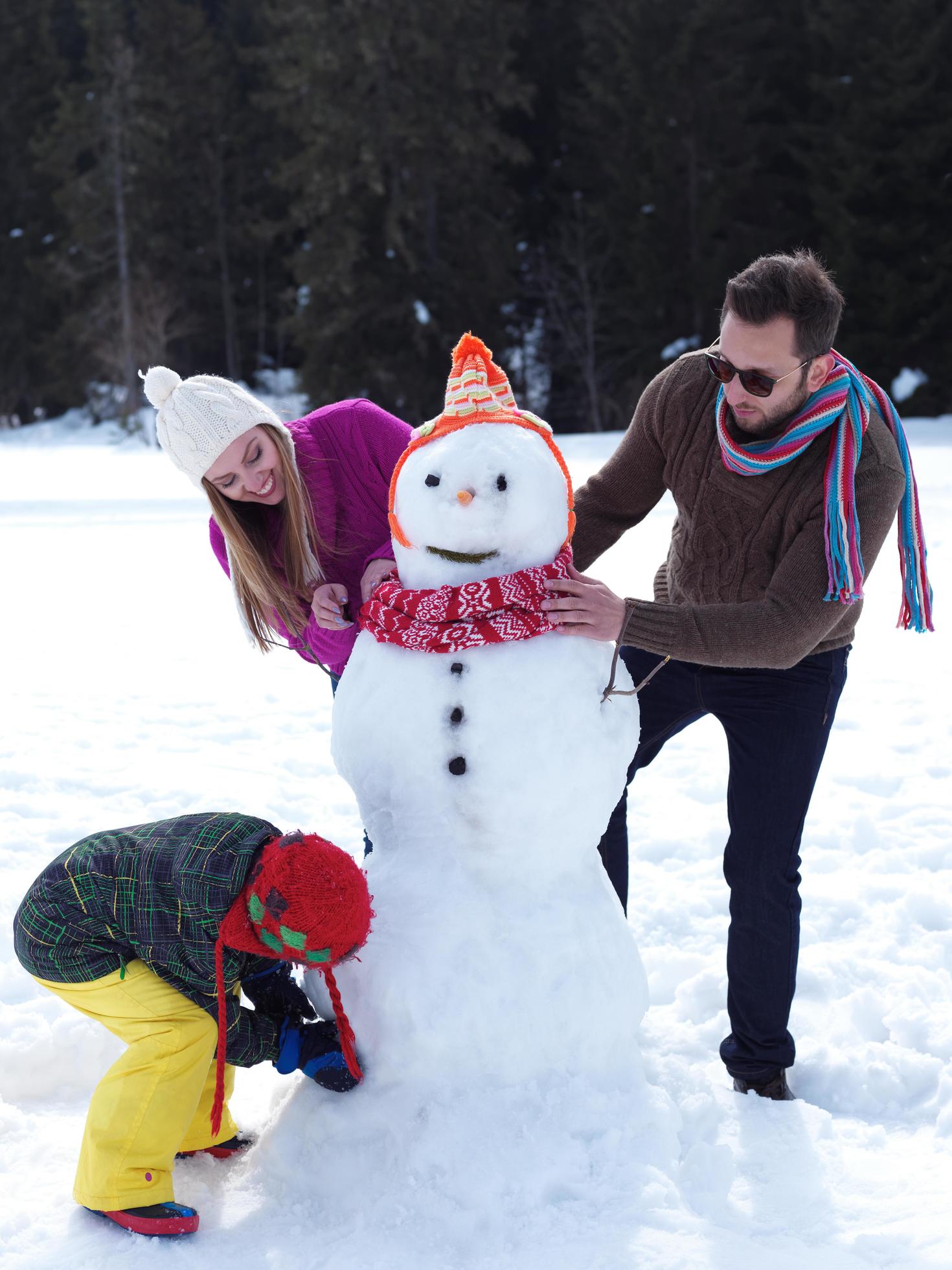 happy family making snowman Stock Free