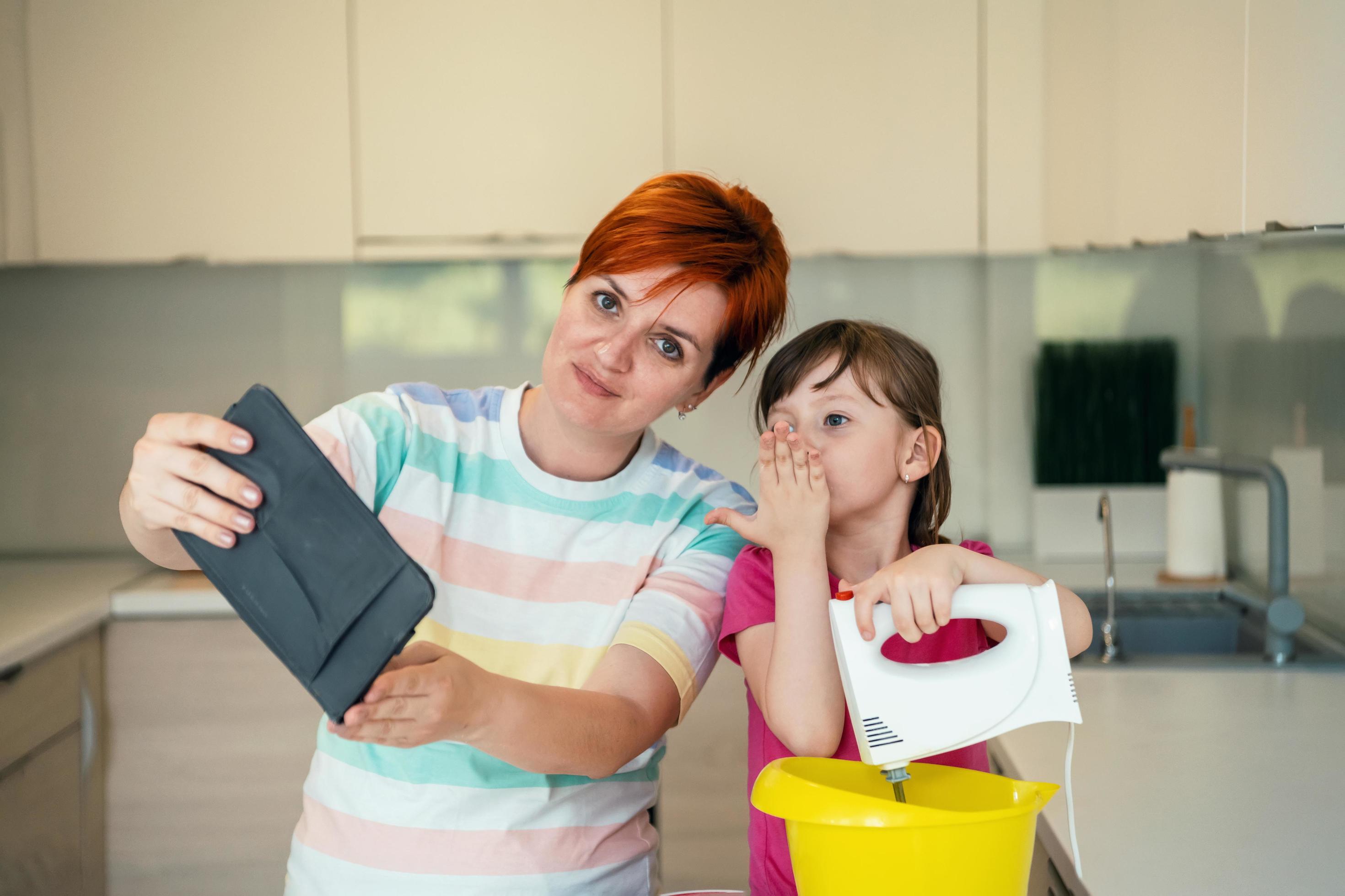 little girl and mom making tastz cake in kithen family having fun at home Stock Free