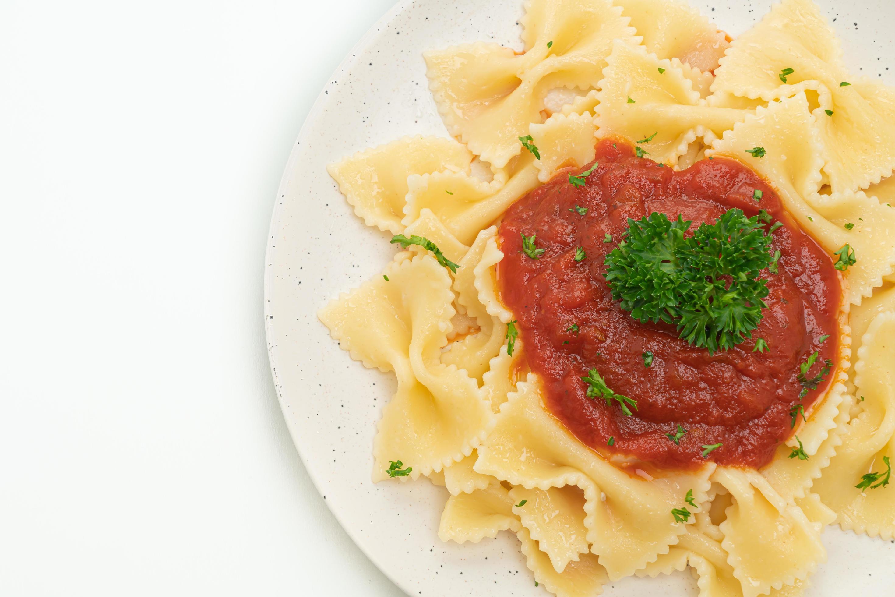 Farfalle pasta in tomato sauce with parsley – Italian food style Stock Free