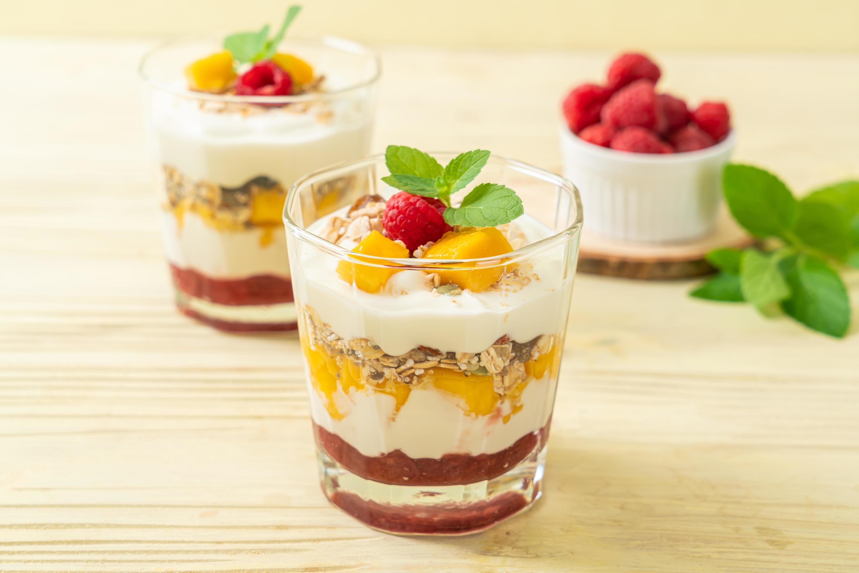 Homemade fresh mango and fresh raspberry with yogurt and granola – healthy food style Stock Free