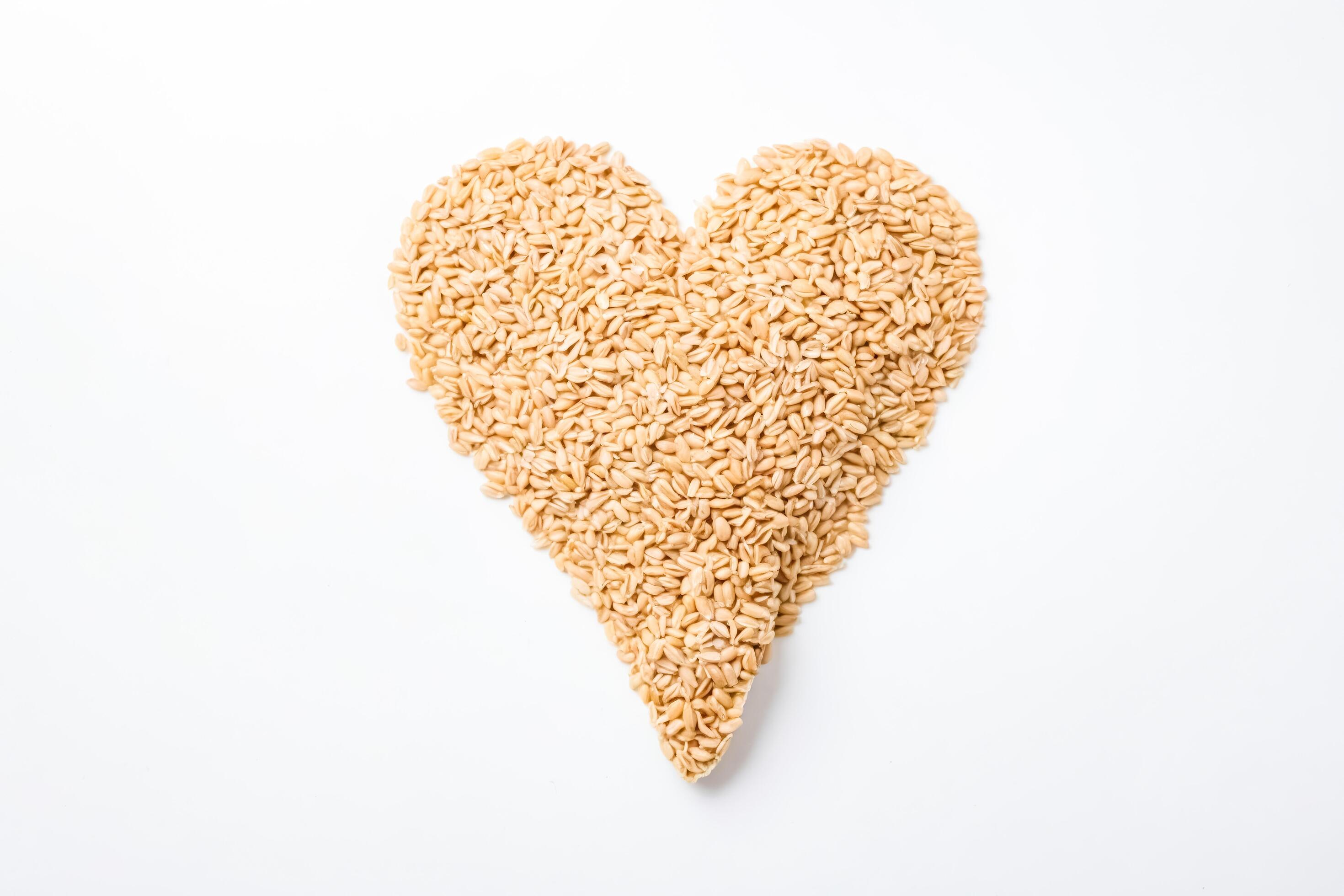 Heart-Shaped Heap of Wheat Grains on White Background Stock Free