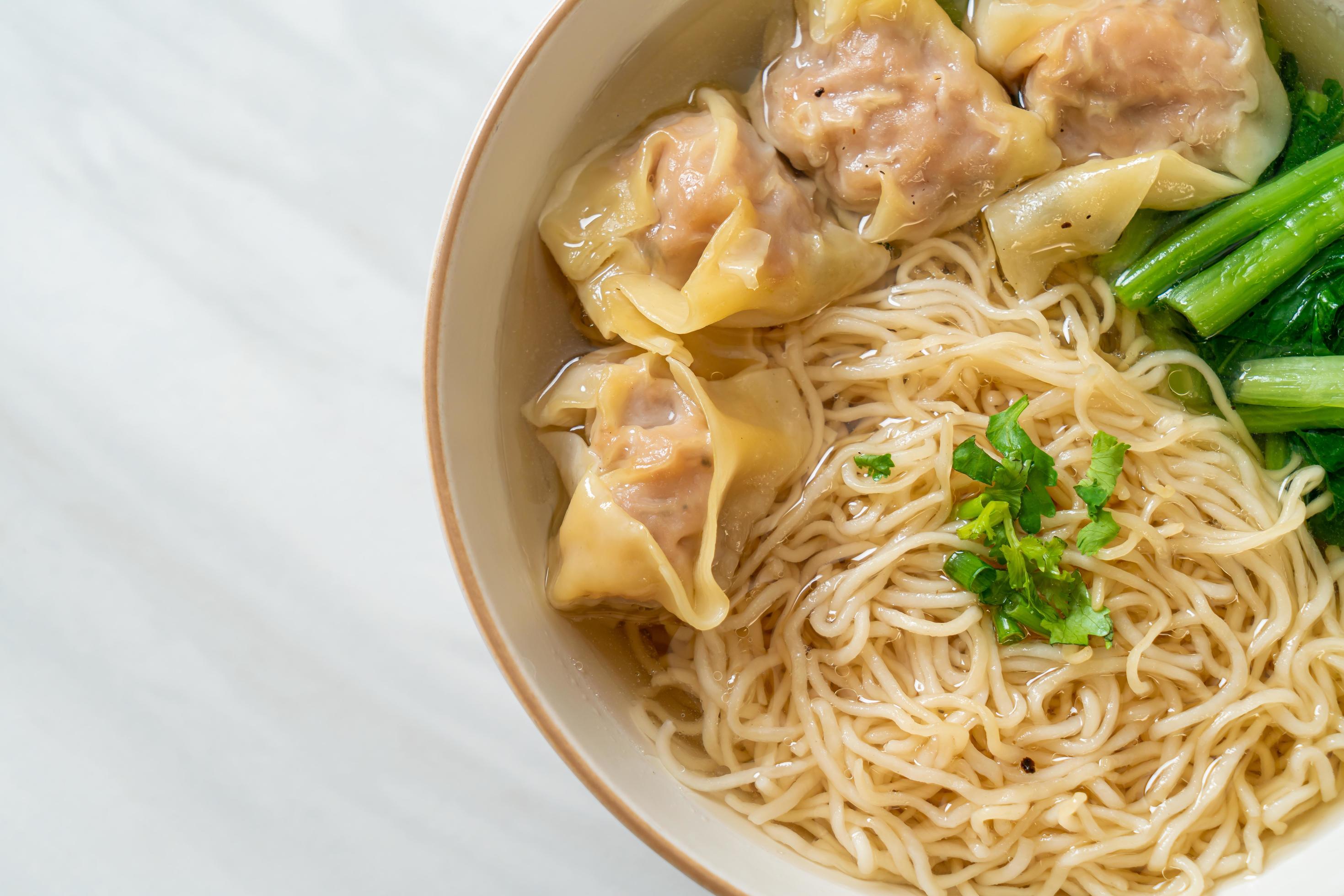 Egg noodles with pork wonton soup or pork dumplings soup and vegetable – Asian food style Stock Free