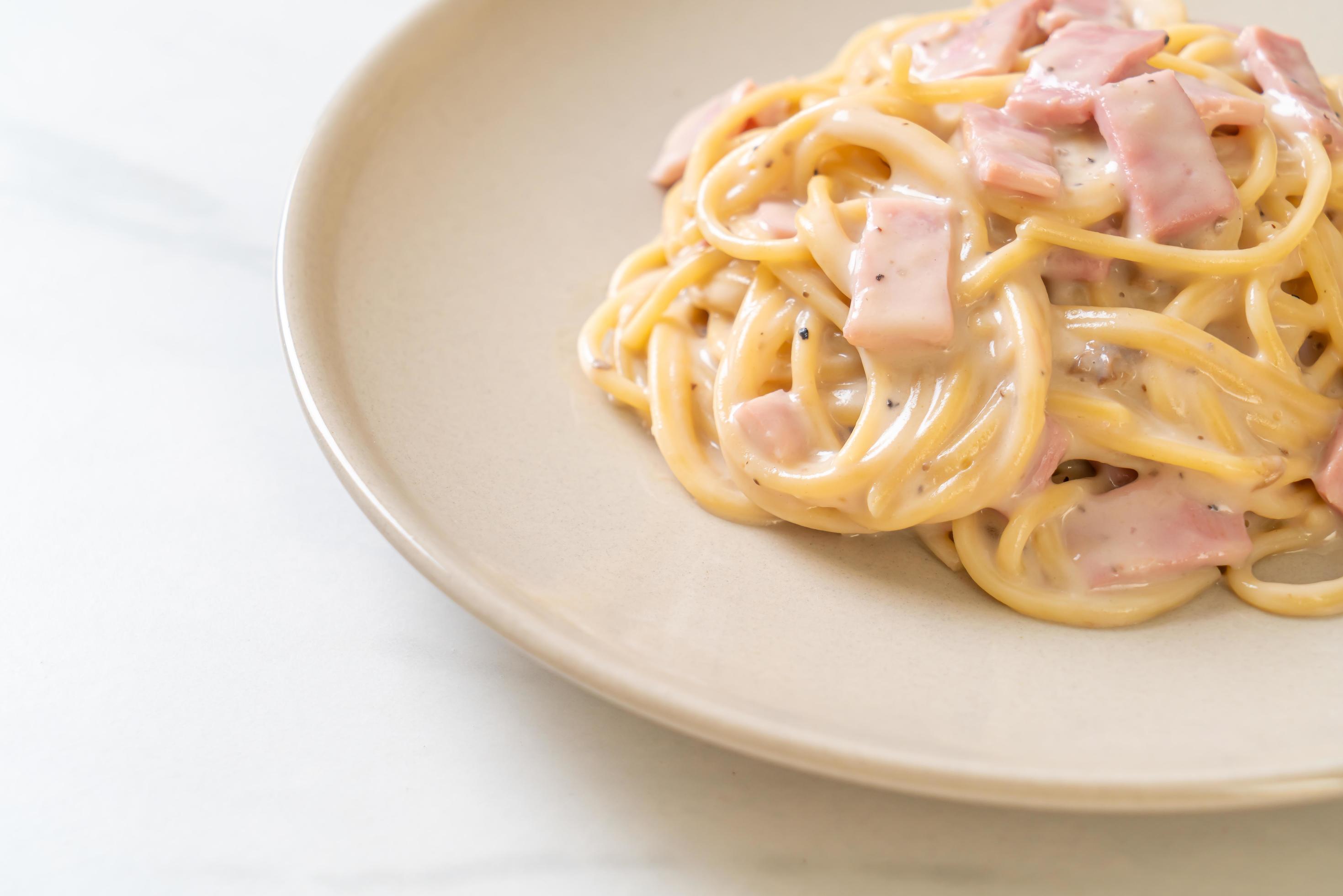 Homemade spaghetti white cream sauce with ham – Italian food style Stock Free