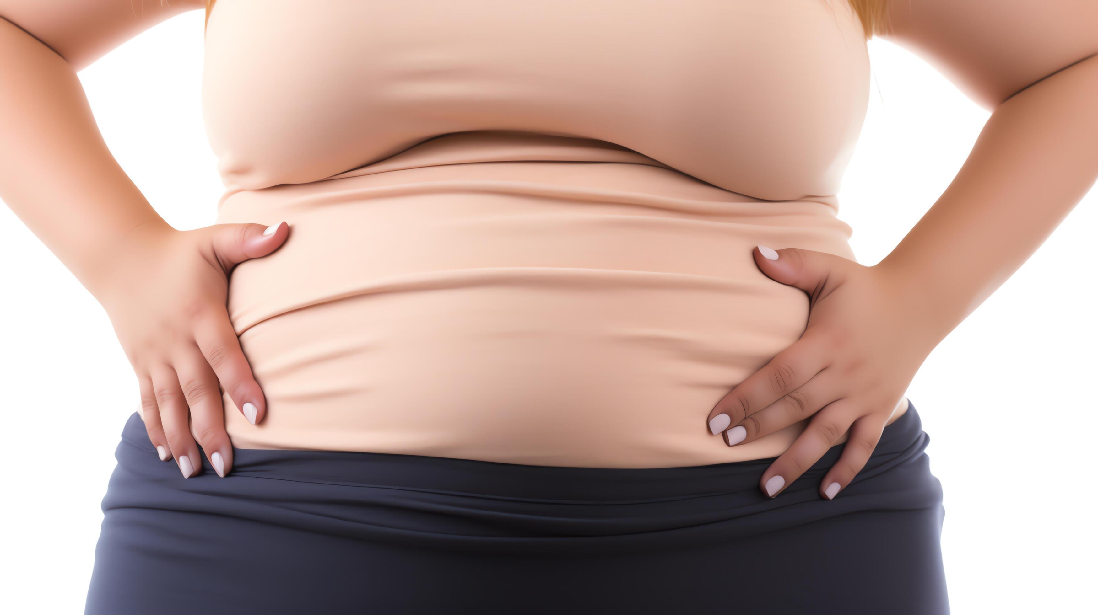 A photo of a woman grabbing her belly fat Stock Free