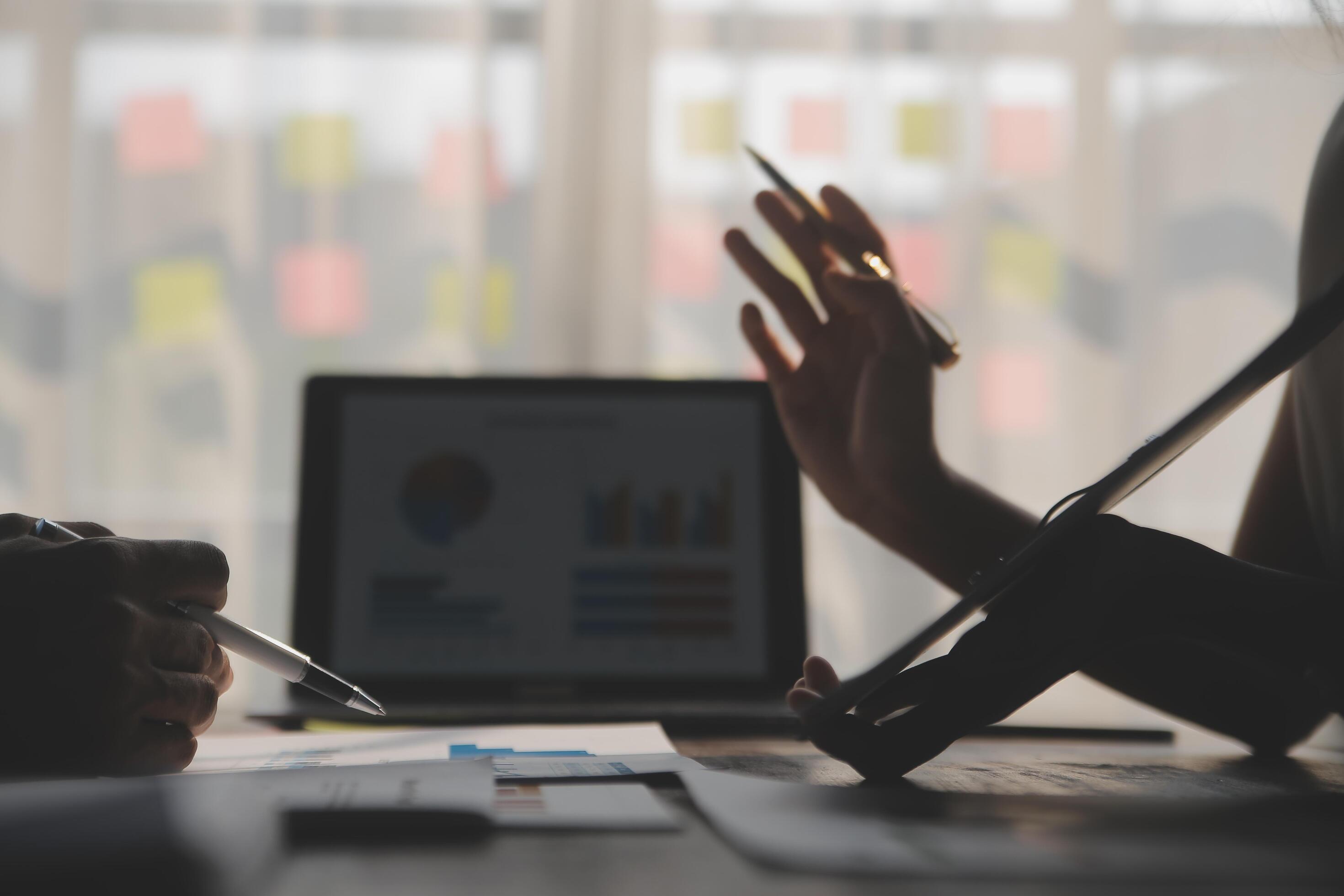 Close up of Business team analyzing income charts and graphs with modern laptop computer. Business analysis and strategy concept. Stock Free