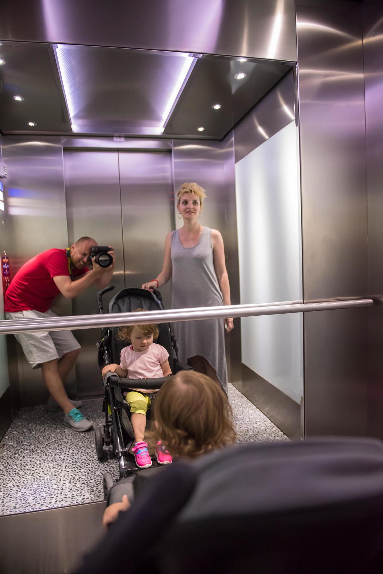 happy family in the elevator Stock Free