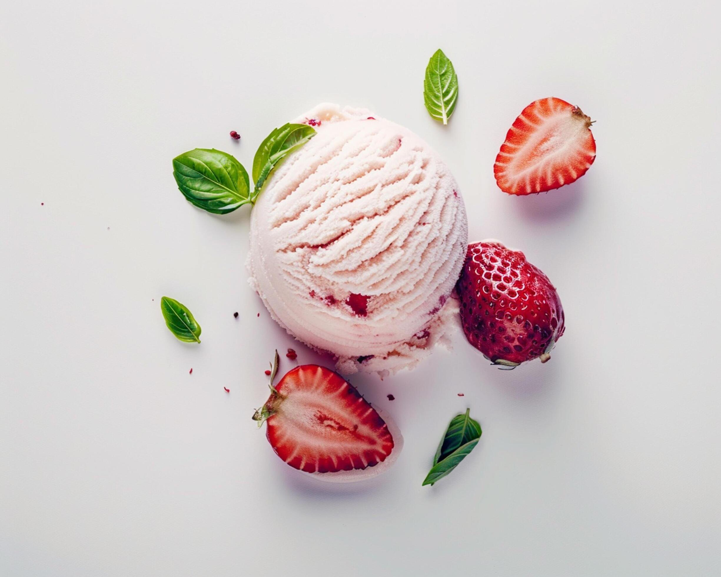 a scoop of ice cream with strawberries and mint leaves Stock Free