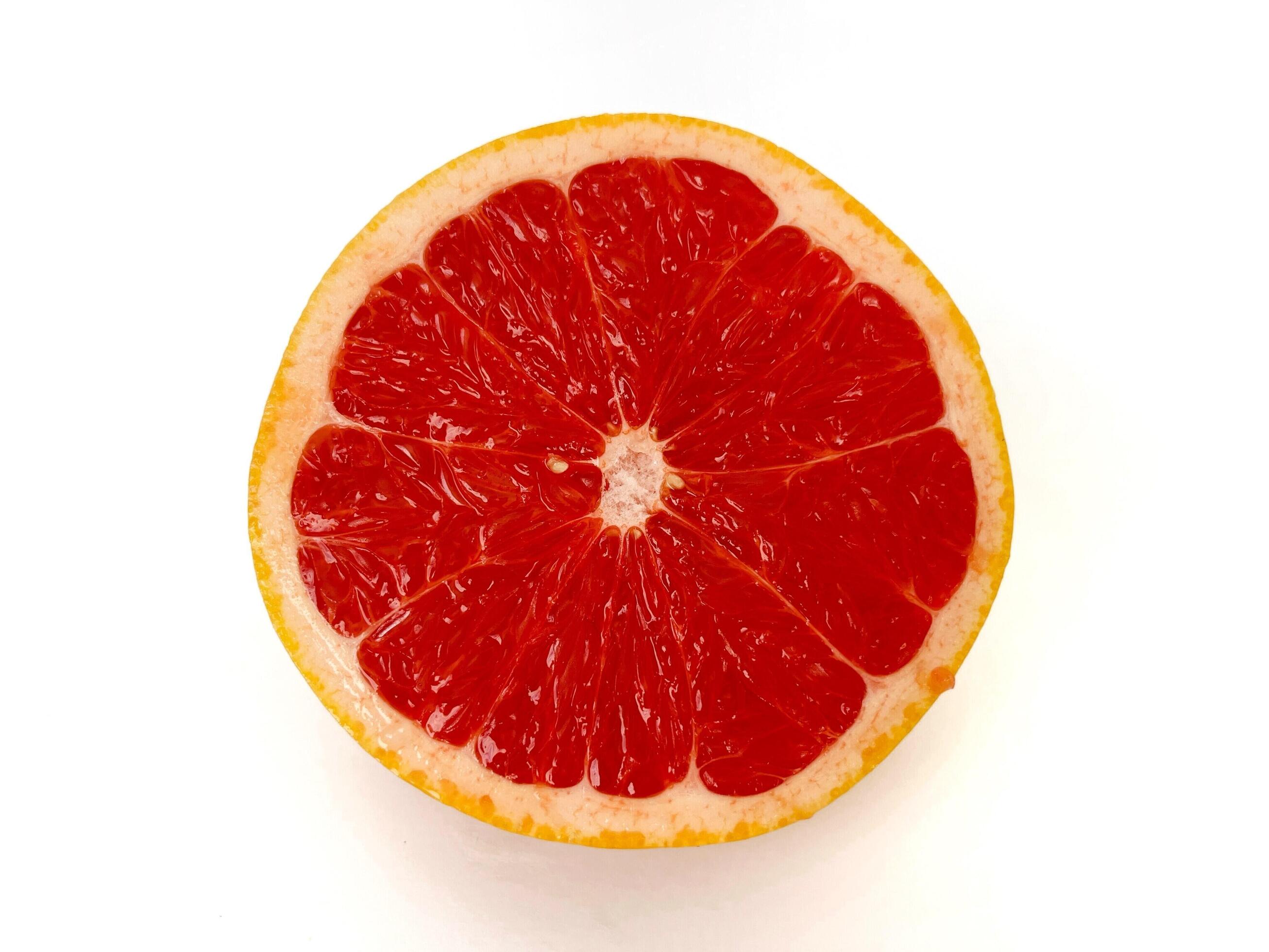 Fresh grapefruit fruit. Half of grapefruit isolated on white background. Grapefruit with clipping path. Stock Free