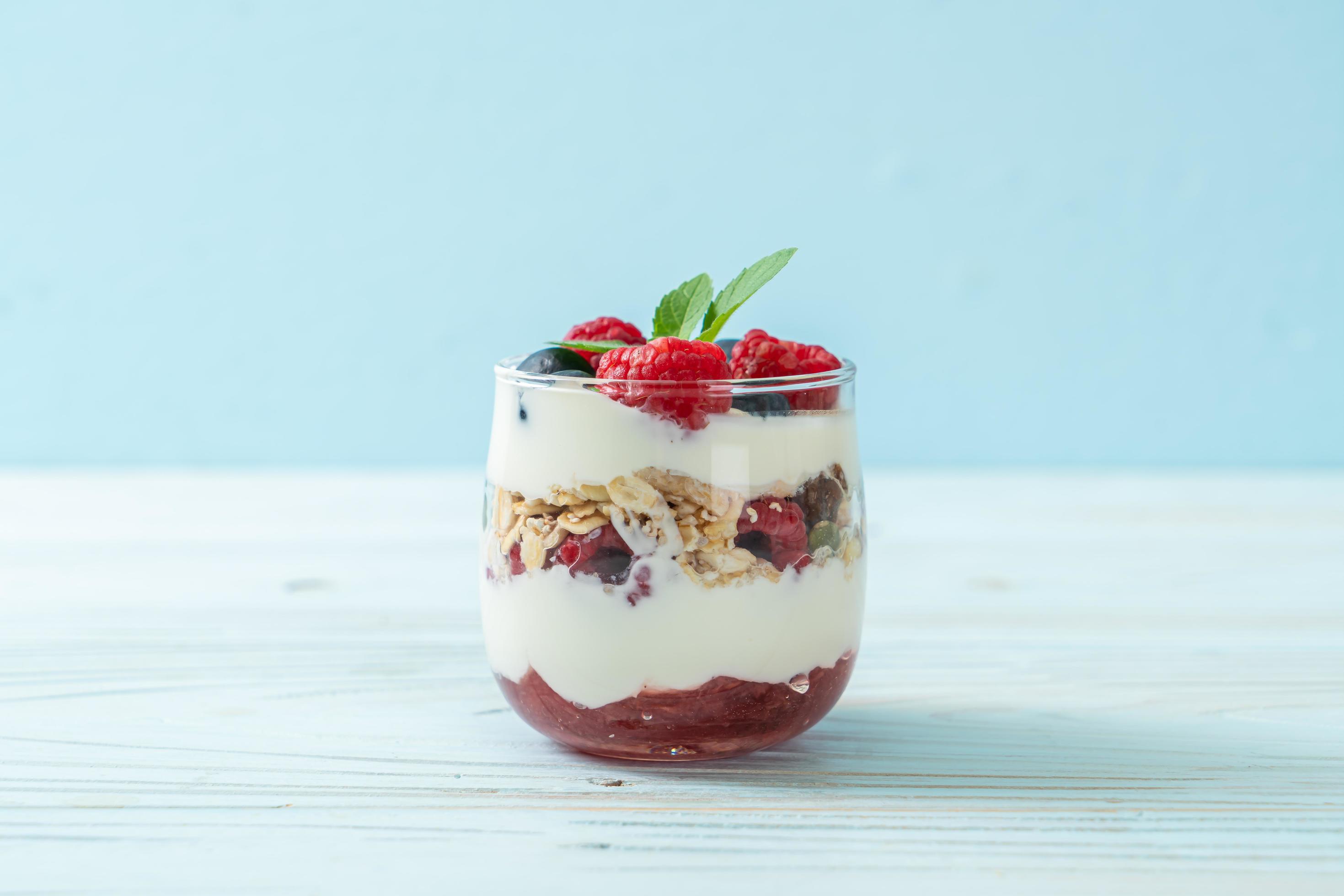 Homemade raspberry and blueberry with yogurt and granola – healthy food style Stock Free