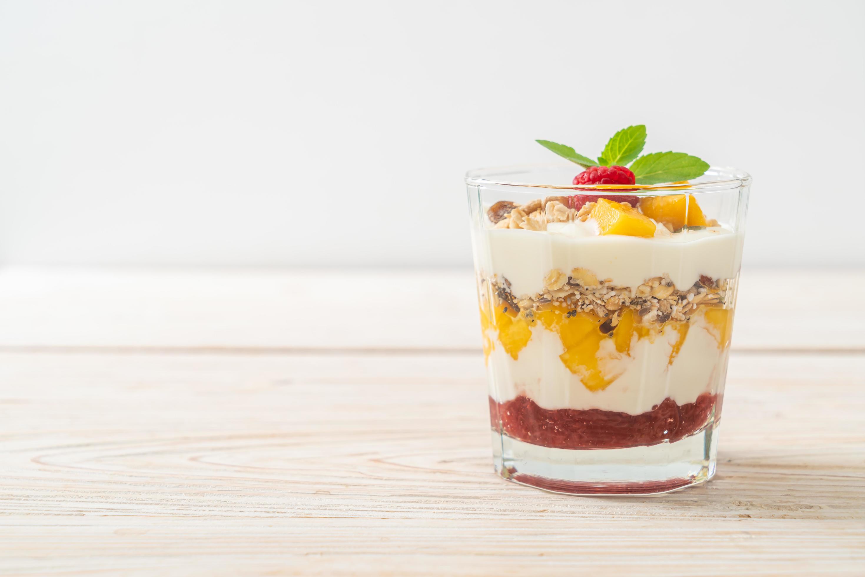 Homemade fresh mango and fresh raspberry with yogurt and granola – healthy food style Stock Free