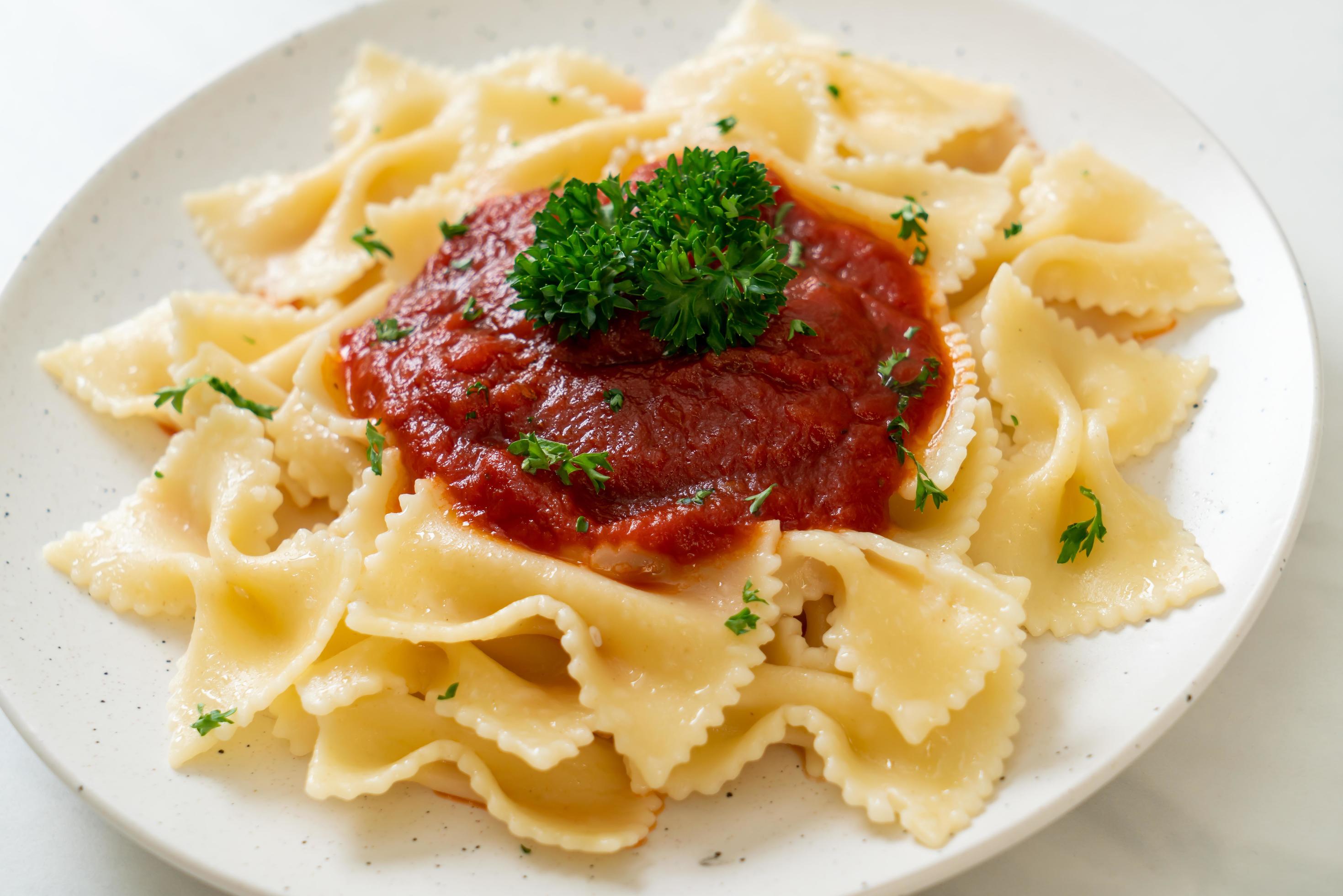 
									Farfalle pasta in tomato sauce with parsley – Italian food style Stock Free