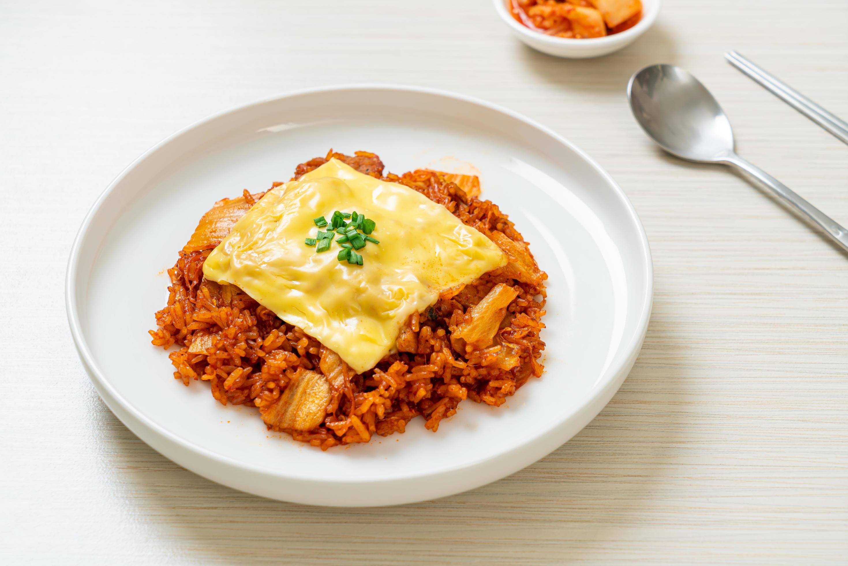 Kimchi fried rice with pork and topped cheese – Asian and fusion food style Stock Free