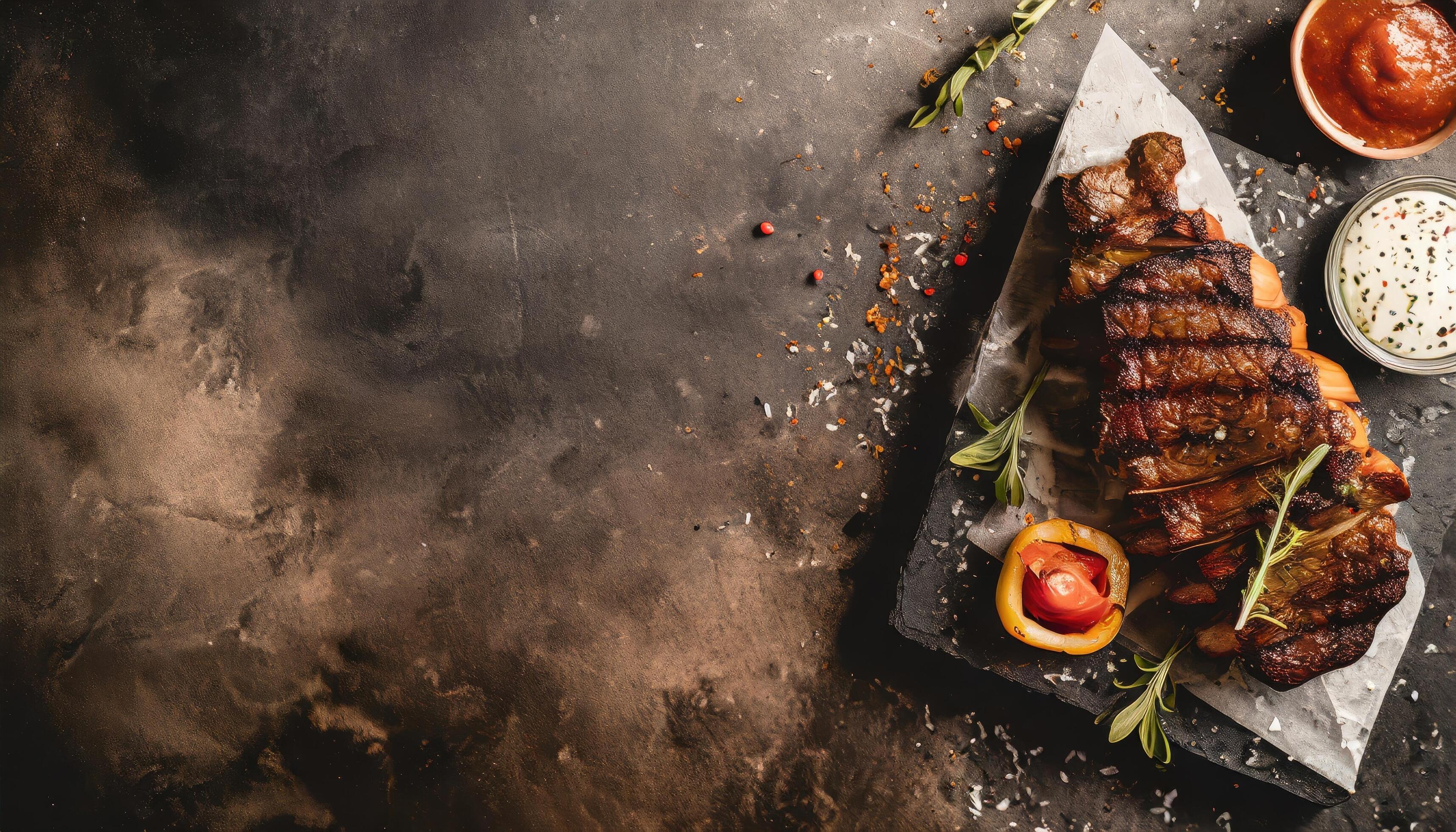 BBQ Grilled rib eye steak, fried rib eye beef meat on a plate with green salad. Dark background. Stock Free