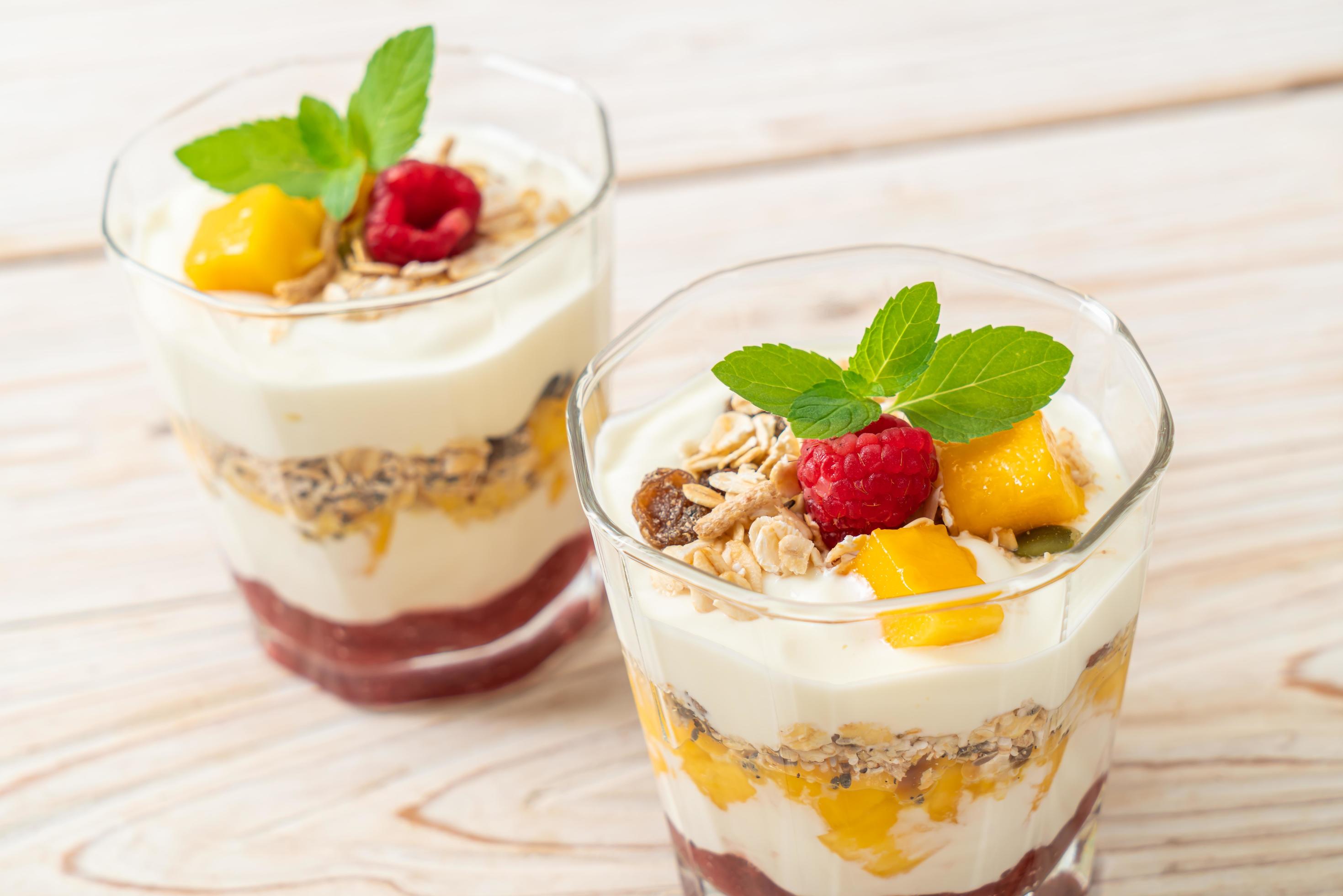 Homemade fresh mango and fresh raspberry with yogurt and granola – healthy food style Stock Free