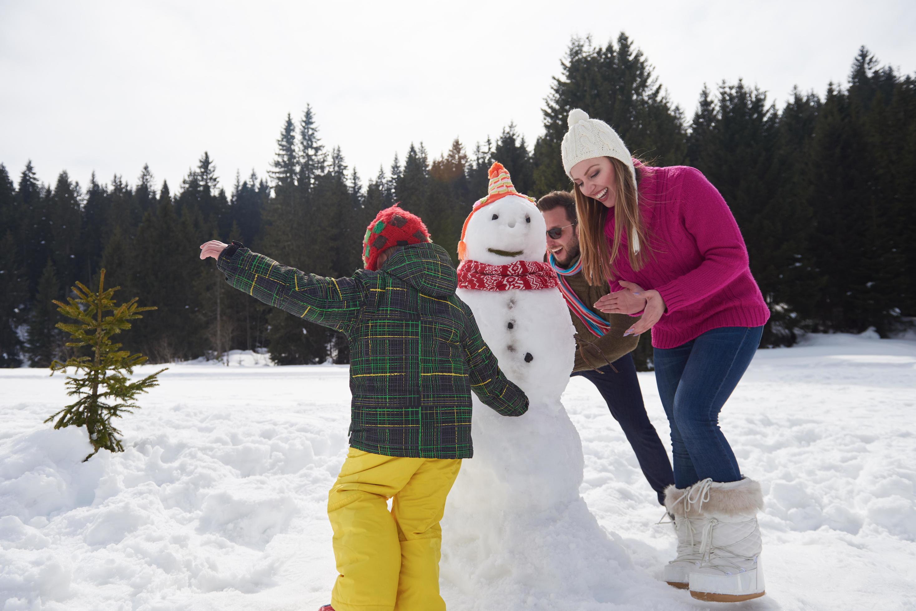 happy family building snowman Stock Free