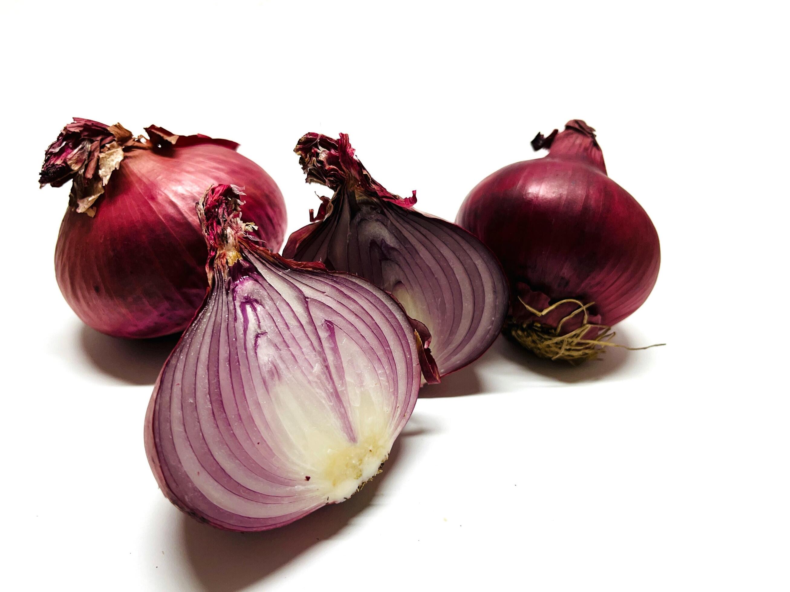 Red whole and sliced onion, isolated on white background. Big red onion Stock Free