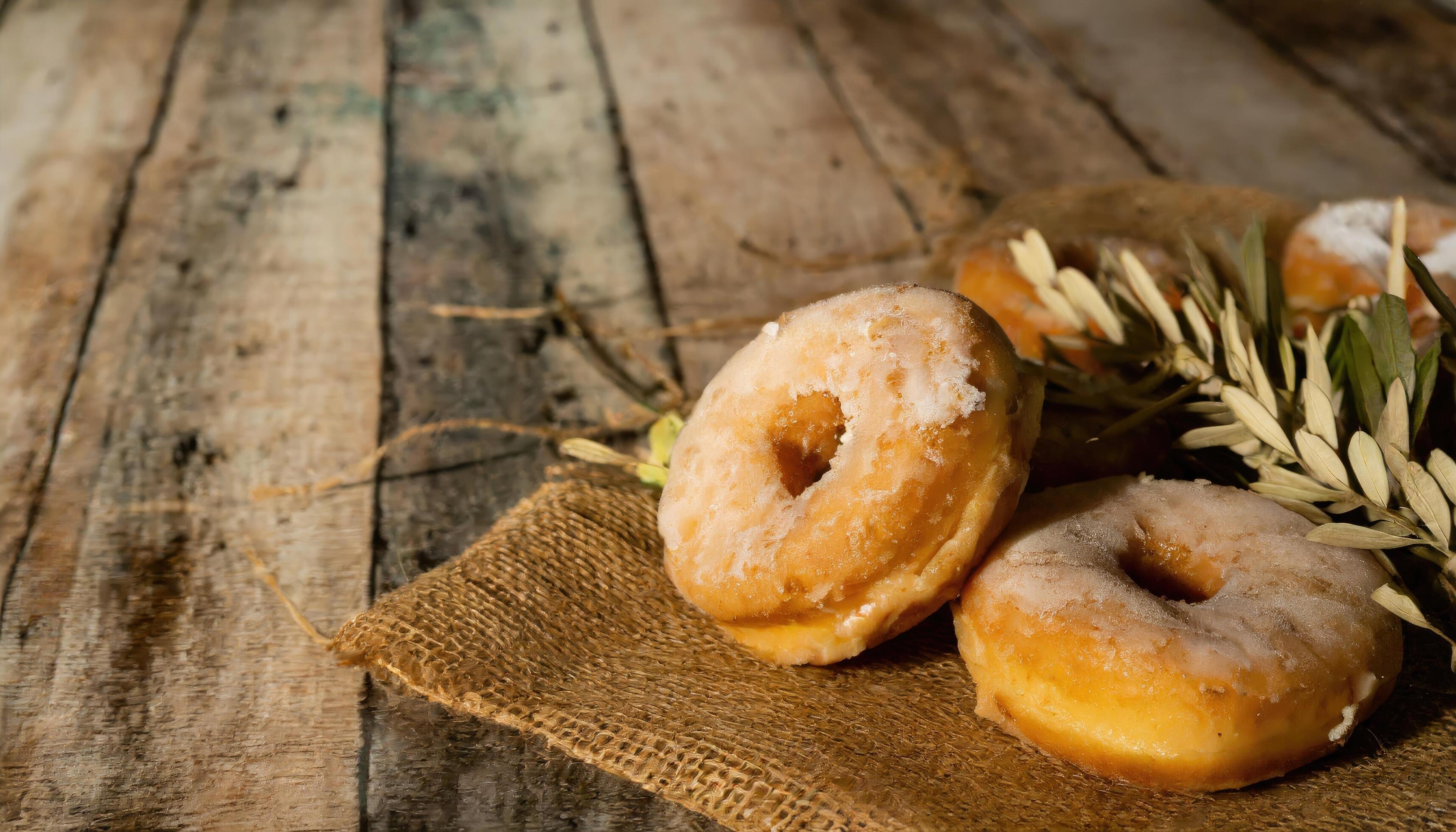 Copy Space image of Donuts with powdered sugar on wooden table on black background Stock Free