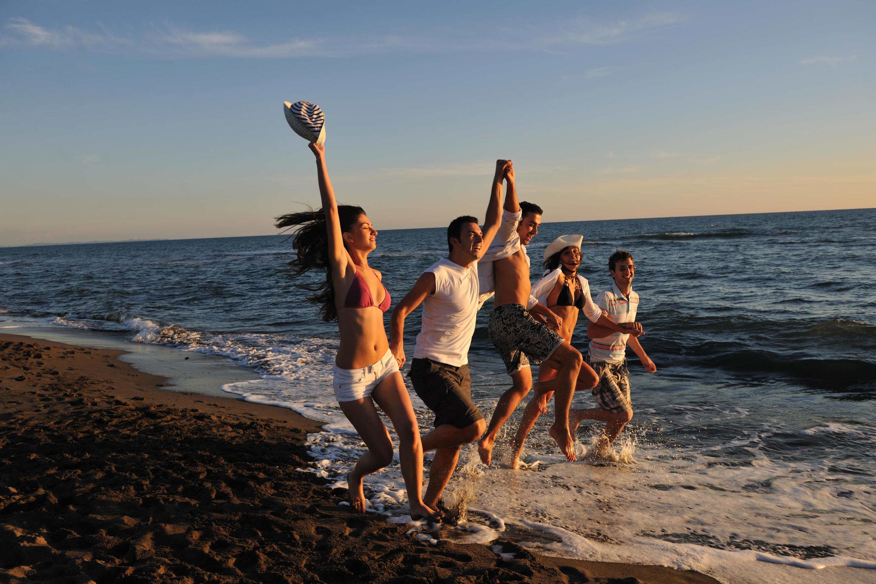 people group running on the beach Stock Free