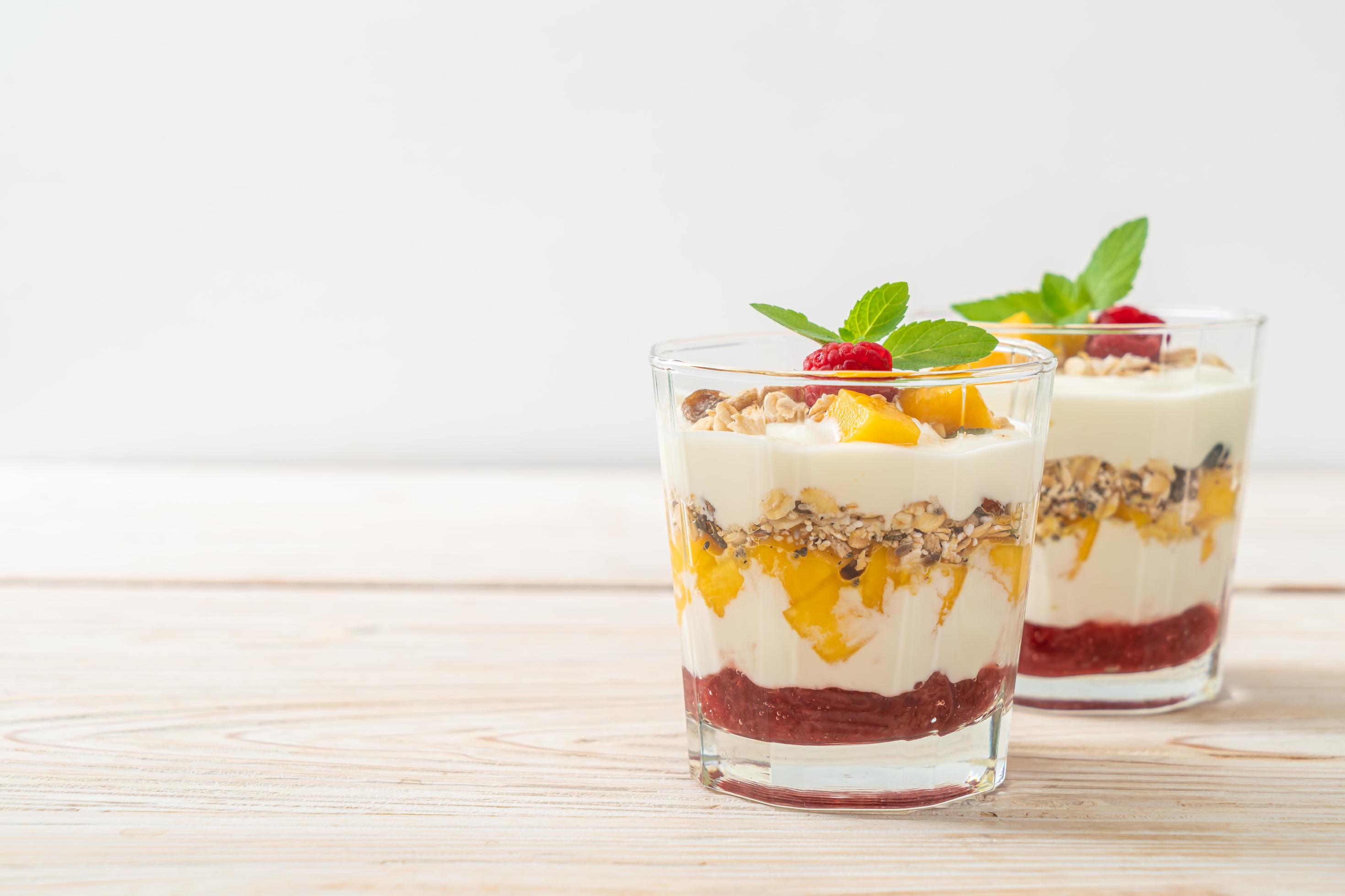 Homemade fresh mango and fresh raspberry with yogurt and granola – healthy food style Stock Free