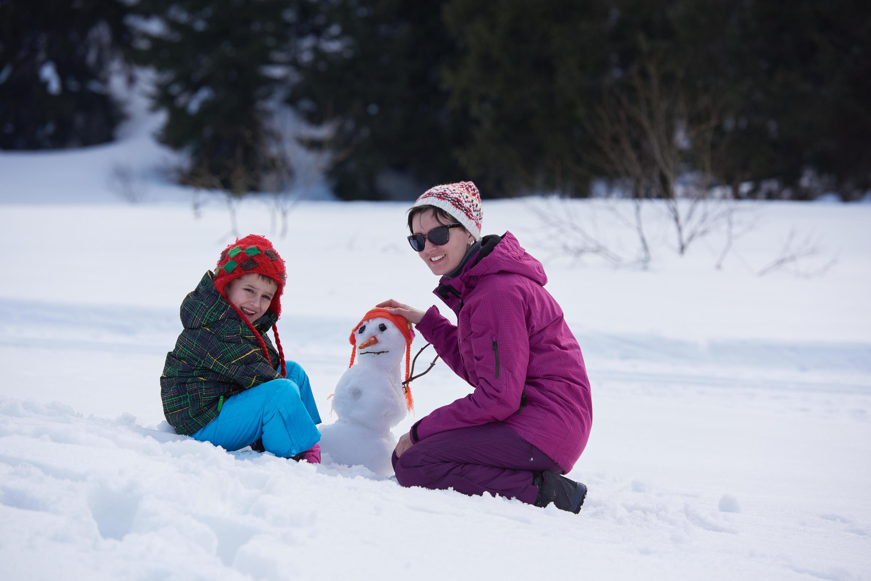 happy family building snowman Stock Free