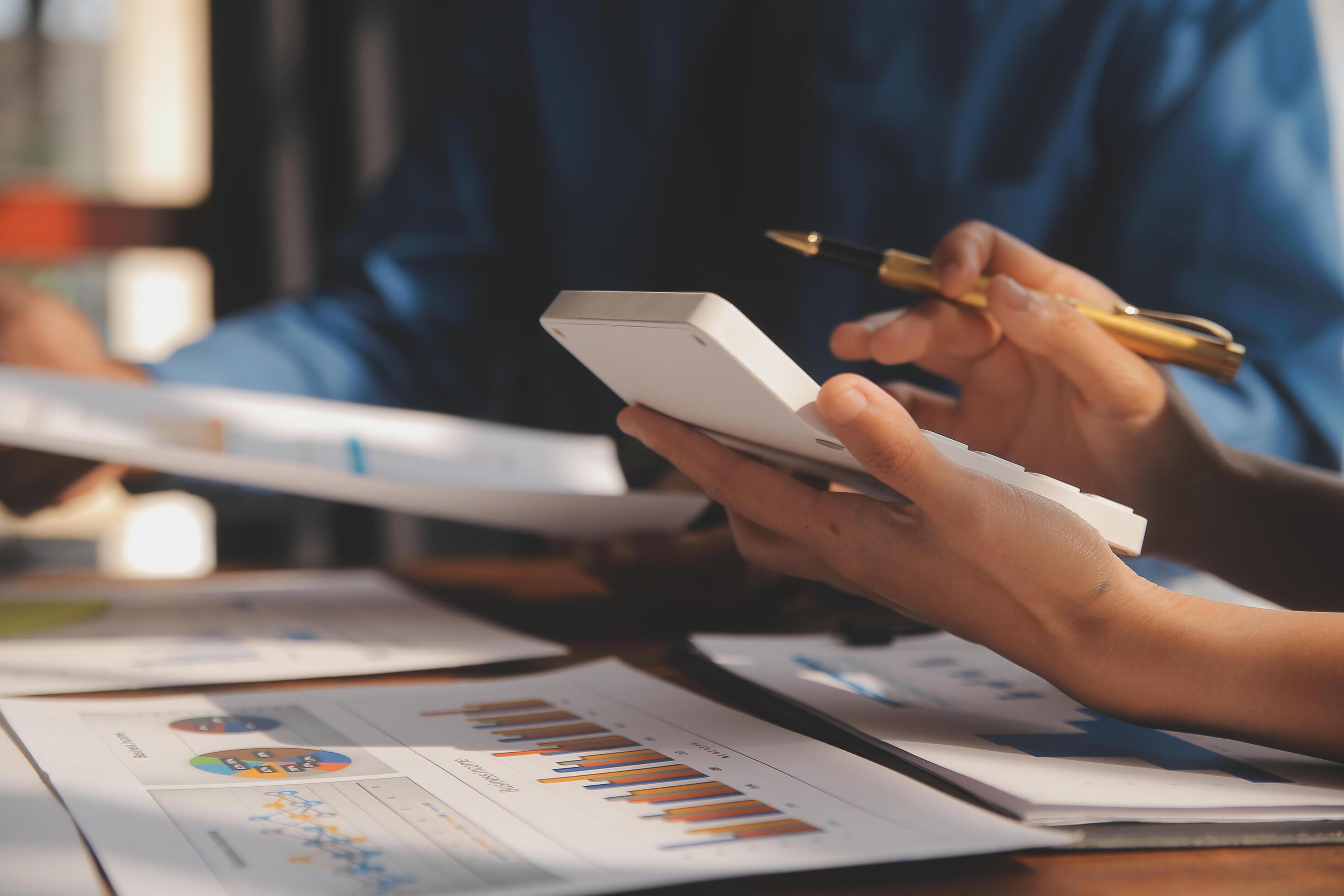 Close up of Business team analyzing income charts and graphs with modern laptop computer. Business analysis and strategy concept. Stock Free