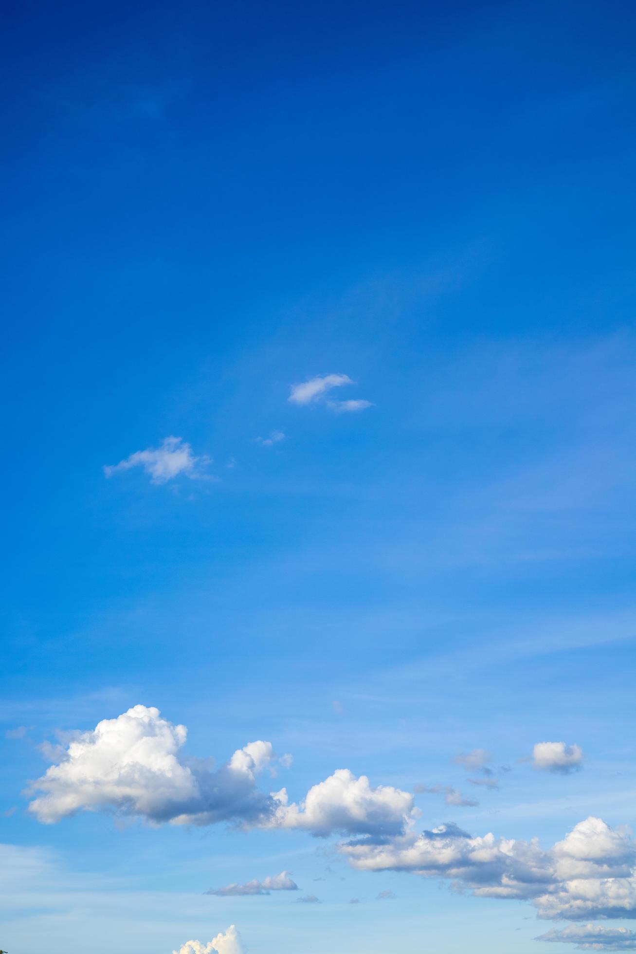 Beautiful bright blue sky with white clouds, nature background concept. Stock Free