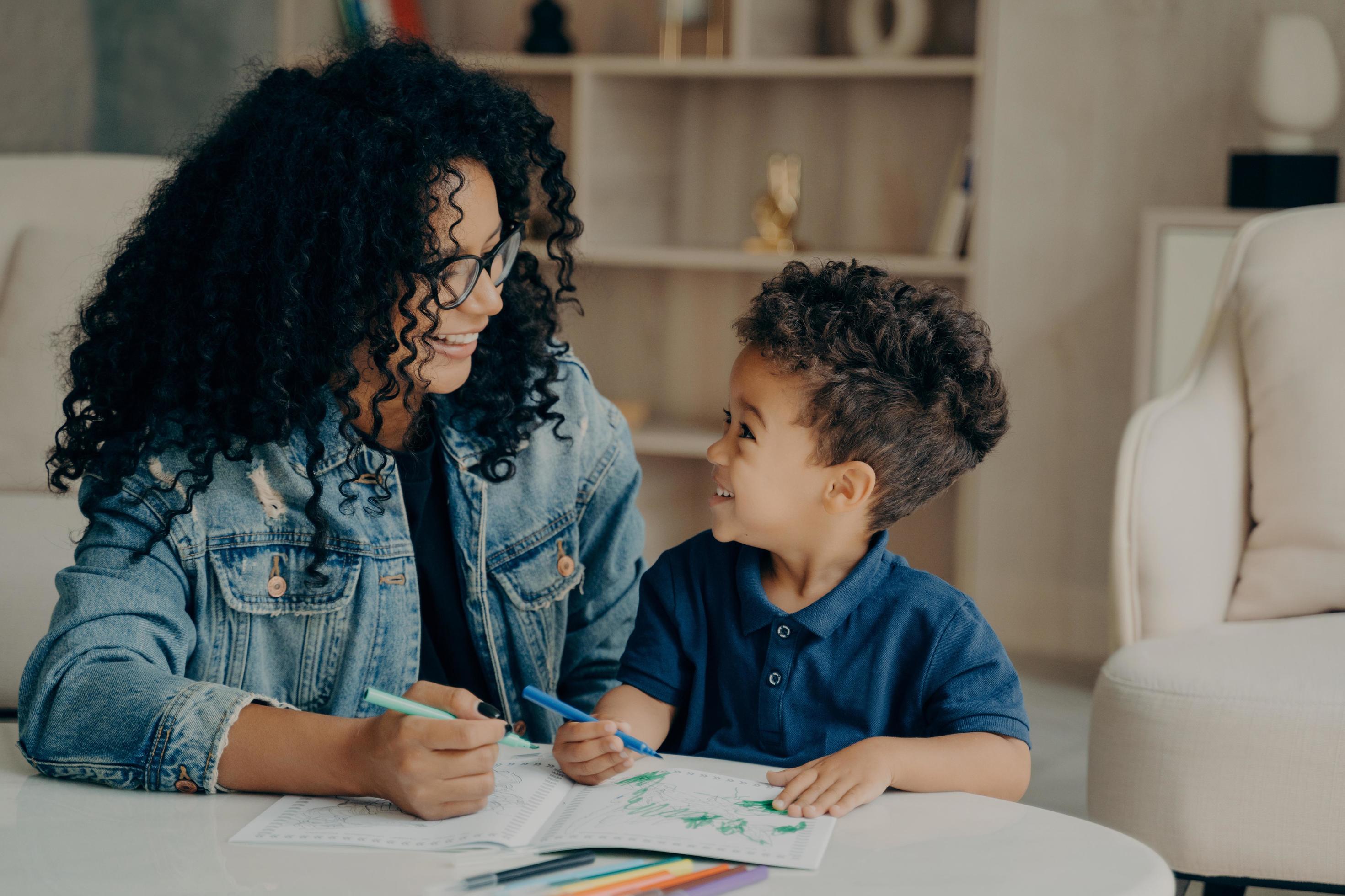 Beautiful afro american family of mother and son spending time at home Stock Free