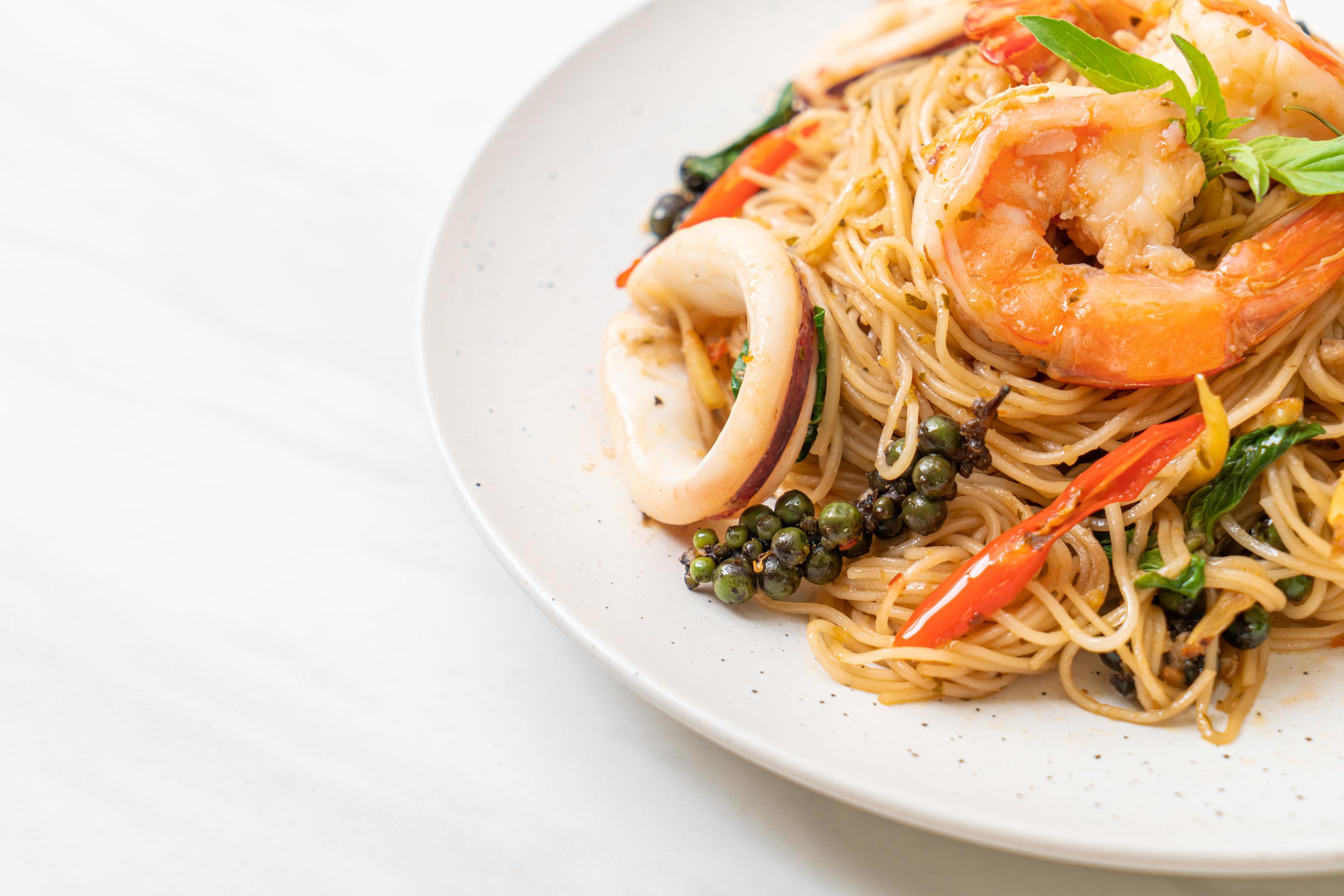 Stir-fried Chinese noodle with basil, chili, shrimp, and squid – Asian food style Stock Free