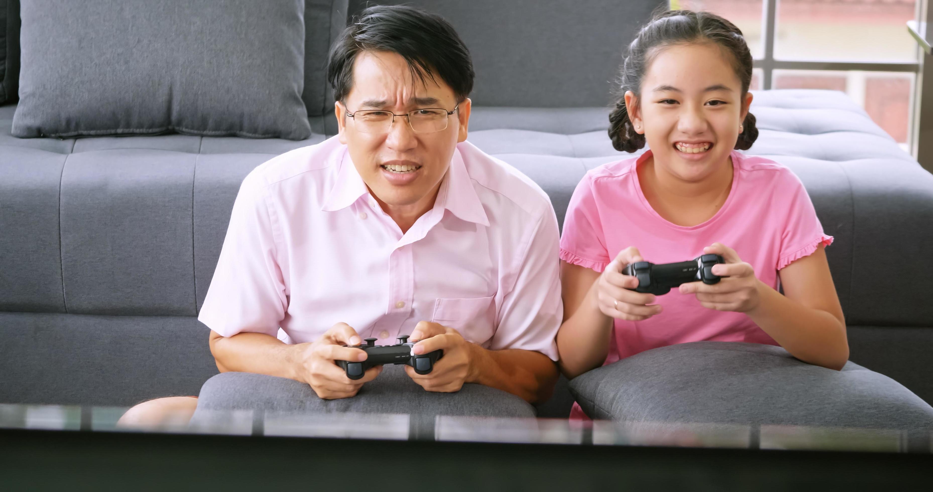 Happy family with father and daughter spending time together at home. Stock Free