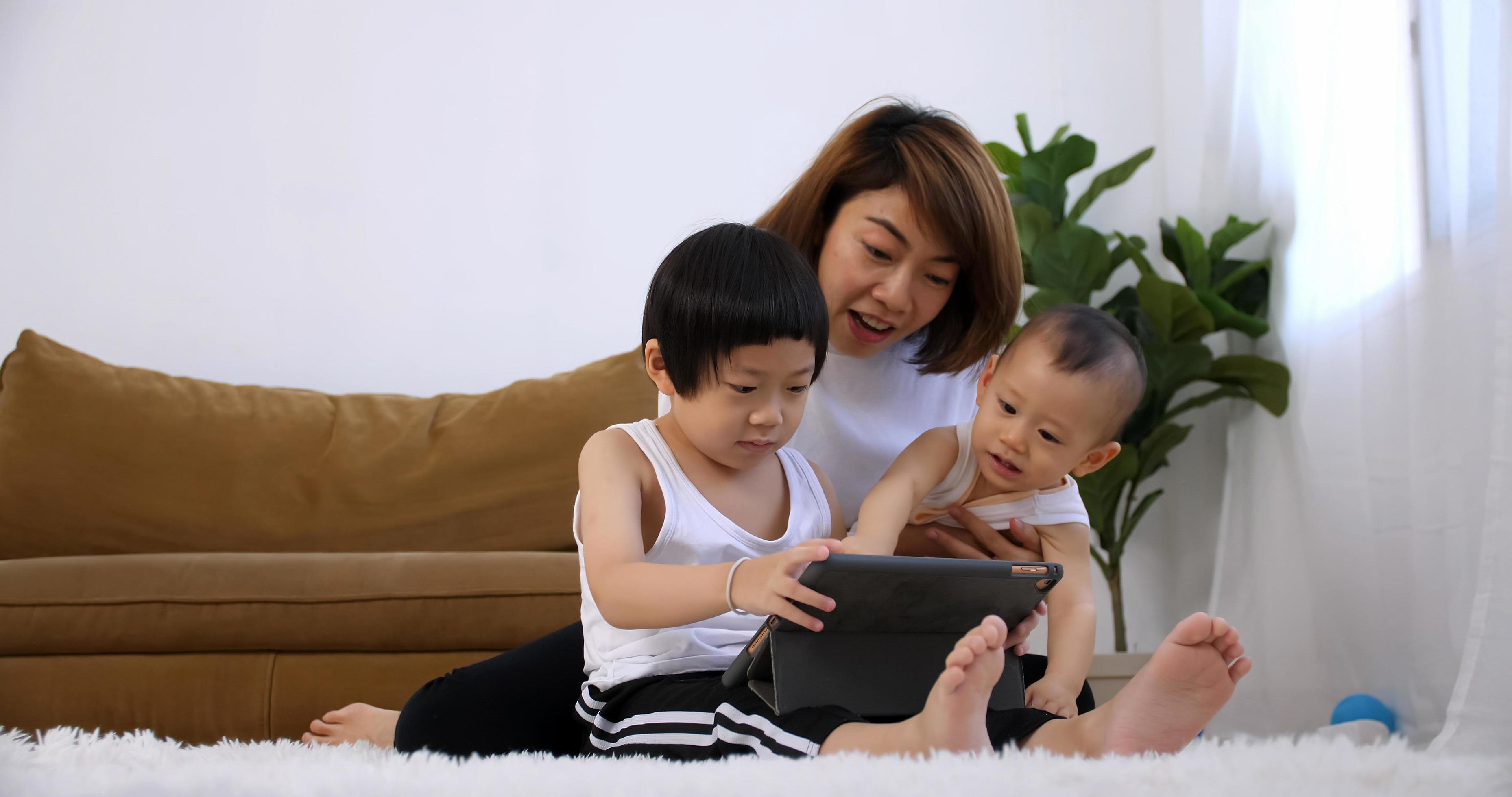 Happy family with mother and kids spending time together at home. Stock Free