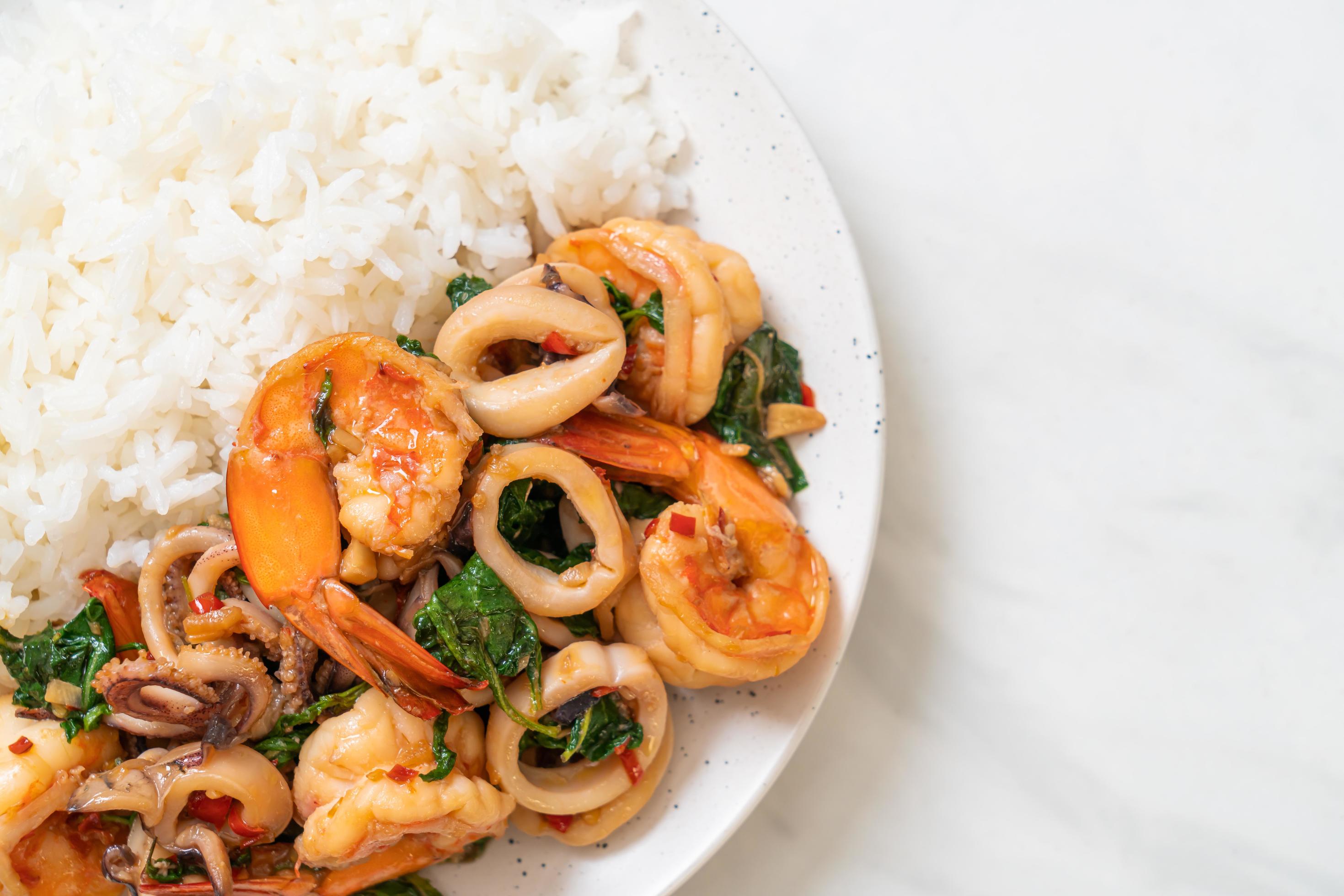 Rice and stir-fried seafood, shrimp and squid, with Thai basil – Asian food style Stock Free