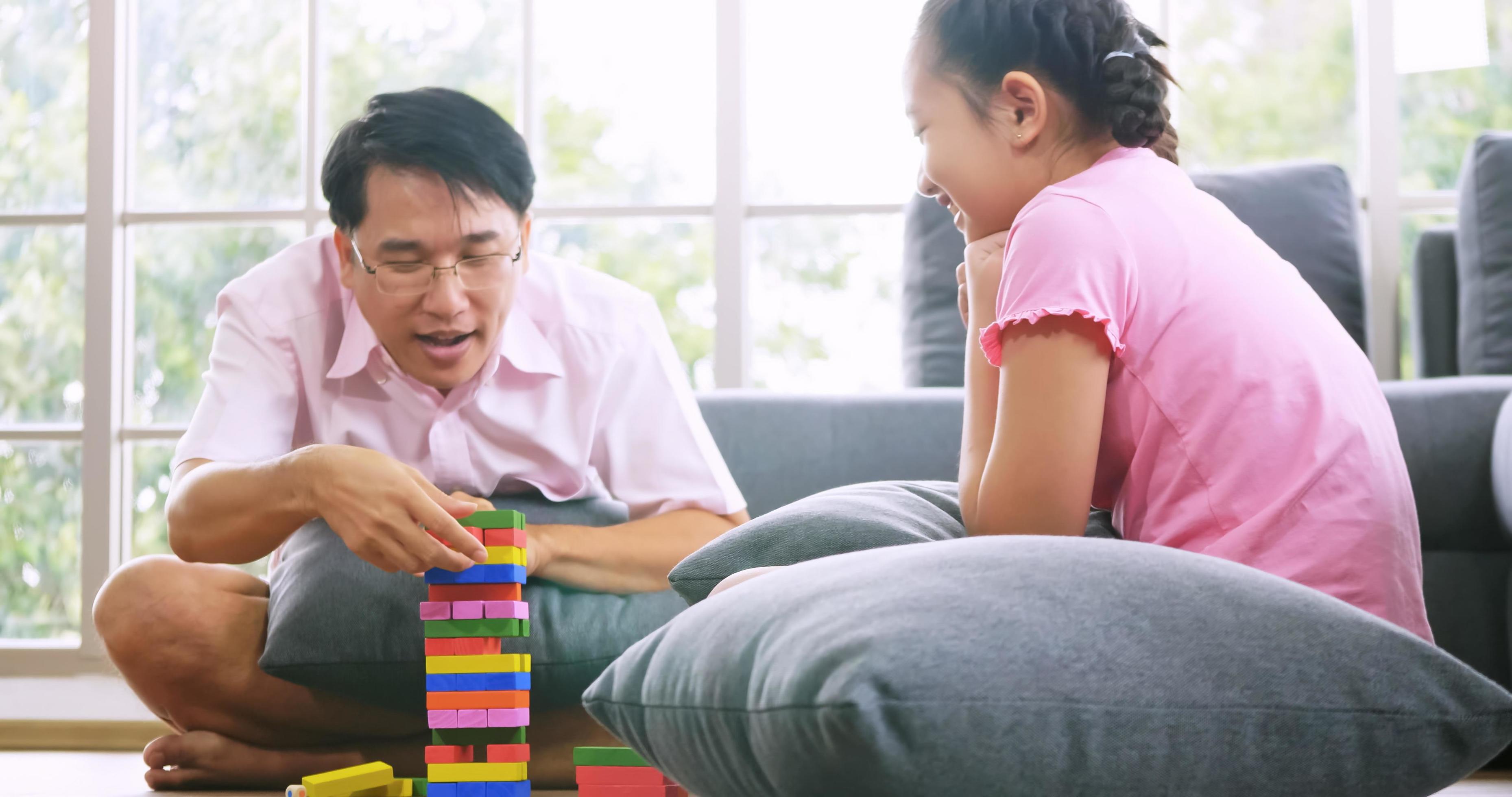 
									Happy family with father and daughter spending time together at home. Stock Free