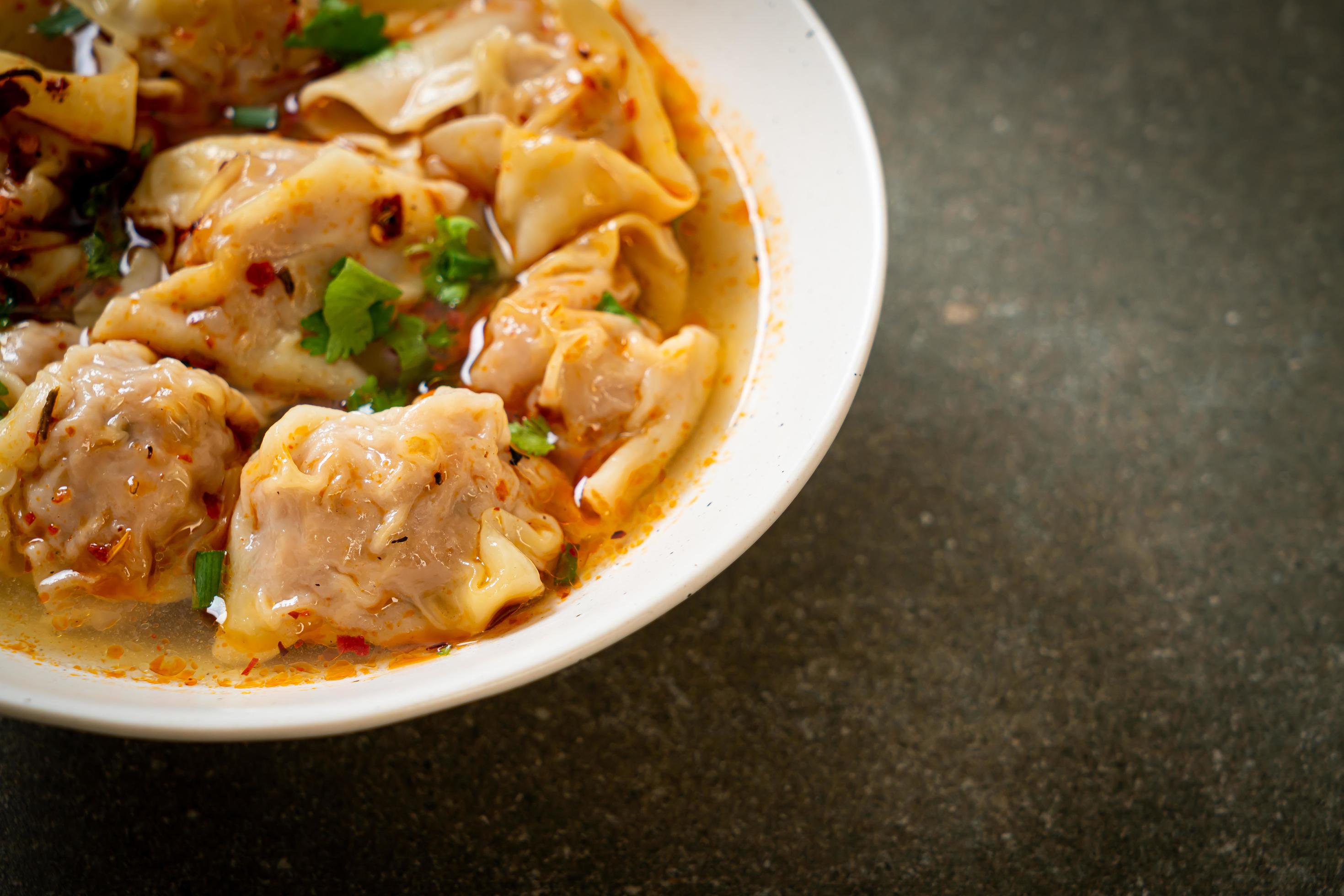 Pork wonton soup or pork dumplings soup with roasted chili – Asian food style Stock Free