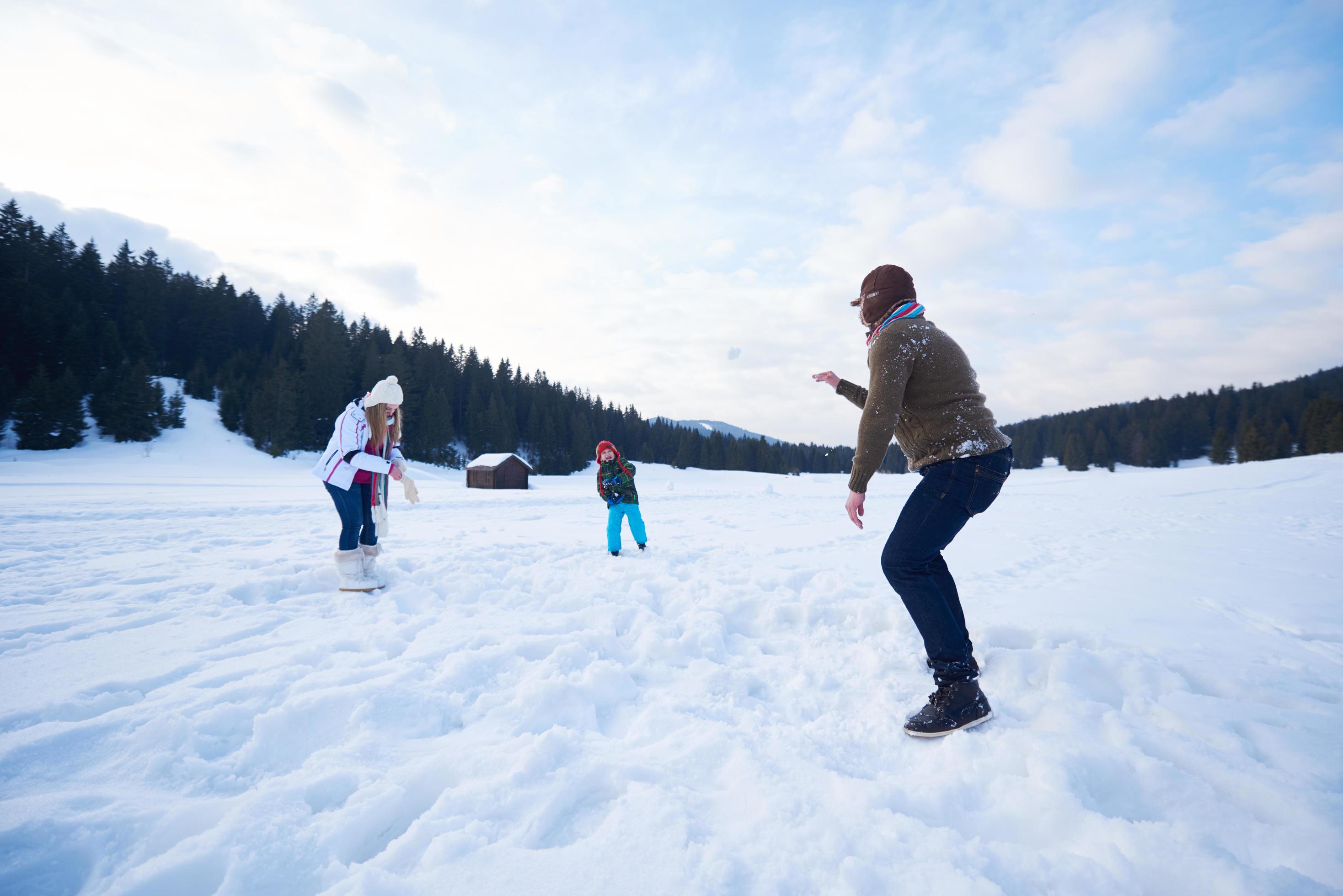 happy family playing together in snow at winter Stock Free