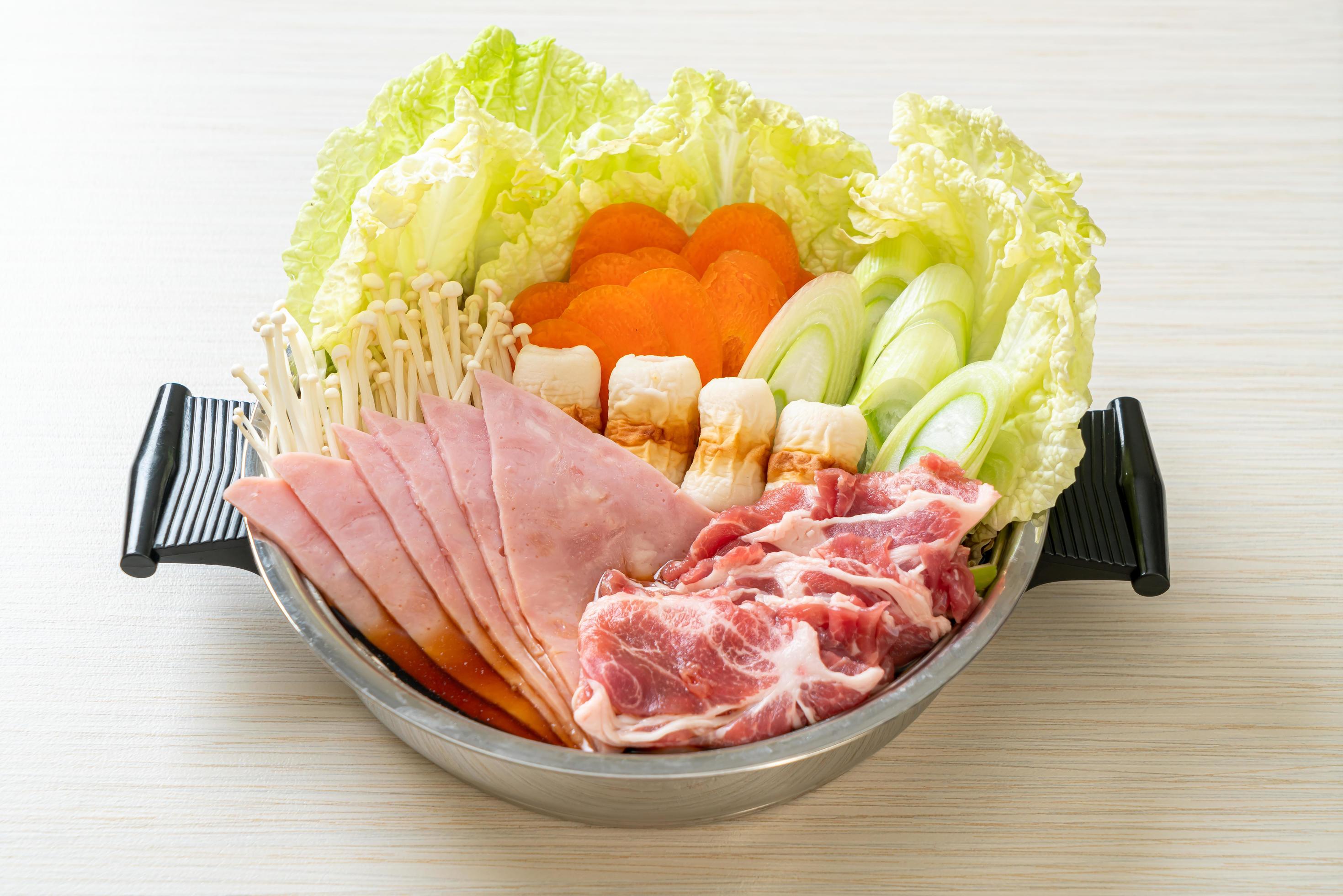 Sukiyaki or shabu hot pot soup with raw meat and vegetables – Japanese food style Stock Free