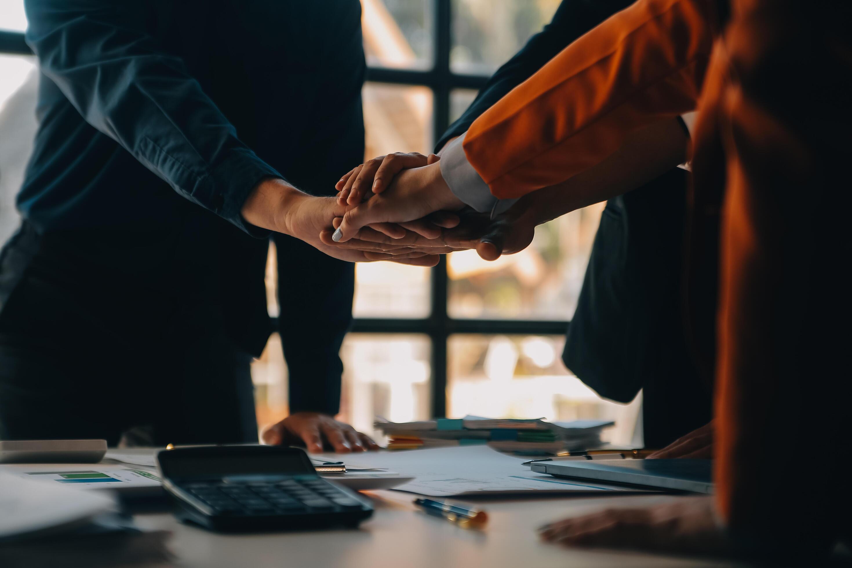 Large business team showing unity with their hands together Stock Free