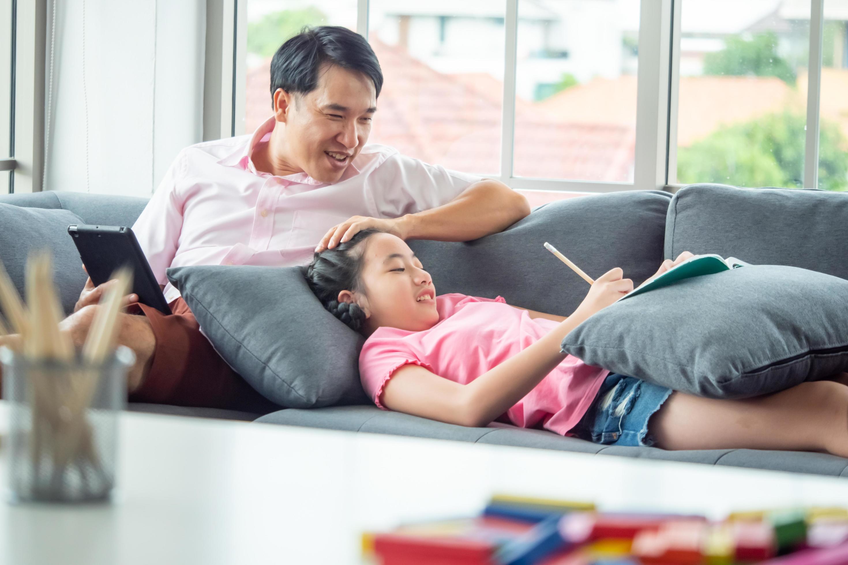 Happy family with father and daughter spending time together at home. Stock Free