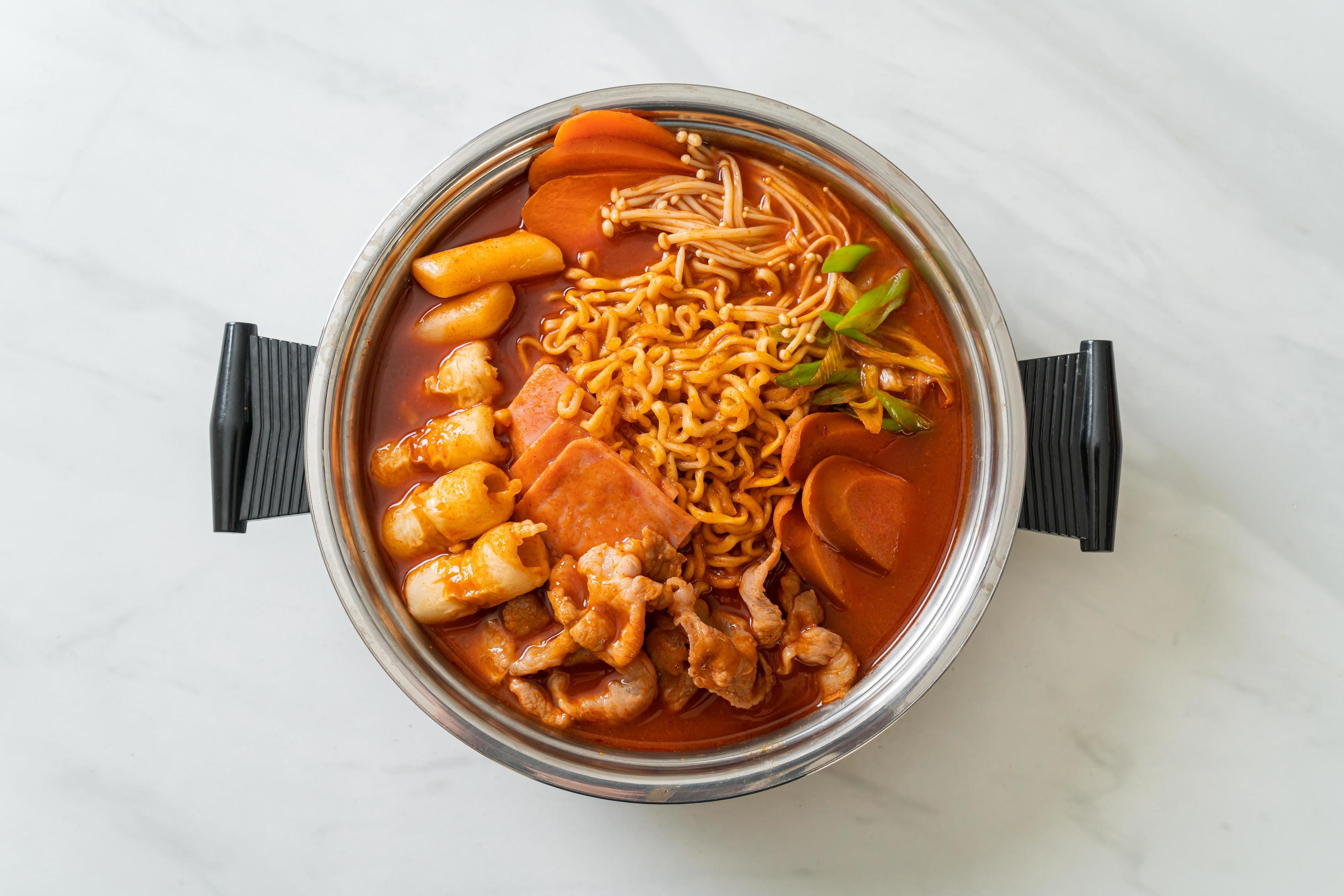 Budae Jjigae or Budaejjigae, Army stew or Army base stew, with kimchi, spam, sausages, ramen noodles, and more – popular Korean hot pot food style Stock Free