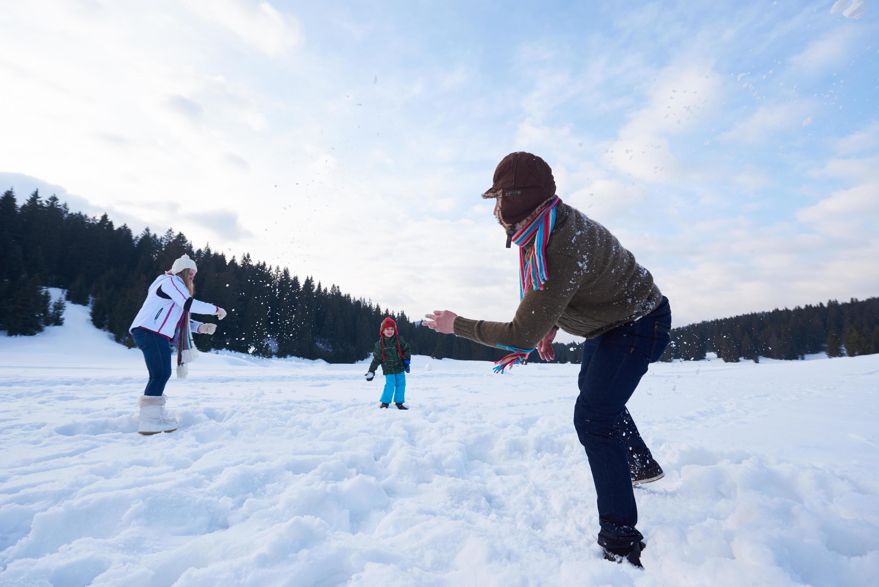 happy family playing together in snow at winter Stock Free