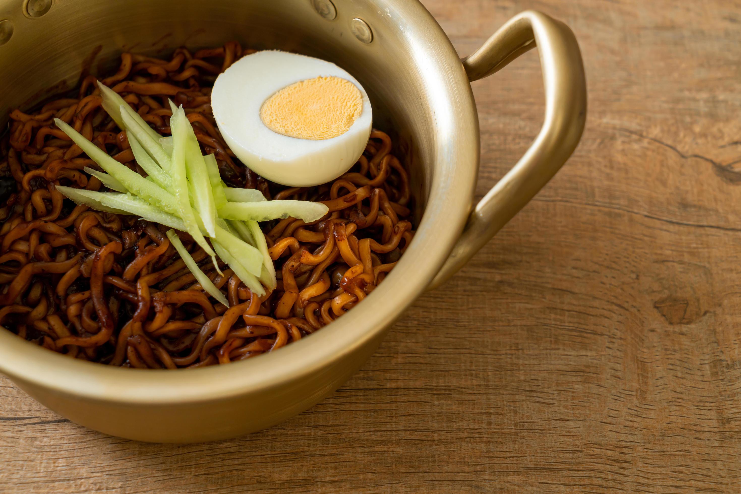 Korean instant noodle with black bean sauce topped with cucumber and boiled egg, Jjajangmyeon – Korean food style Stock Free