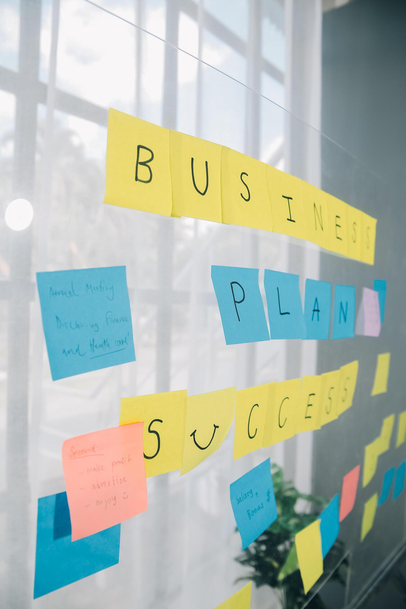 Young creative team professional using post it notes in glass wall to writing strategy business plan to development grow to success. Stock Free