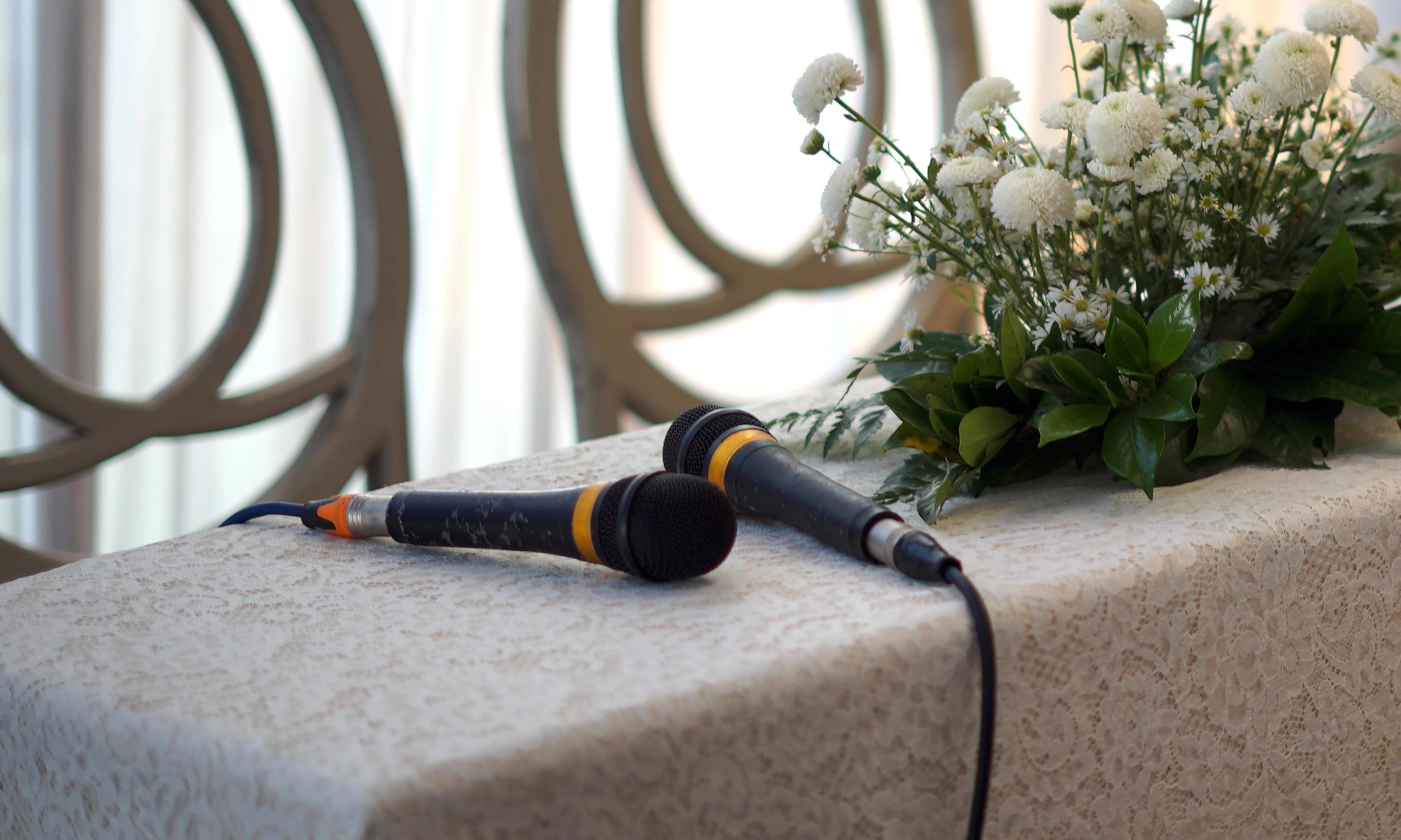 Two Microphones and Flowers on a Table for Wedding Procession Stock Free