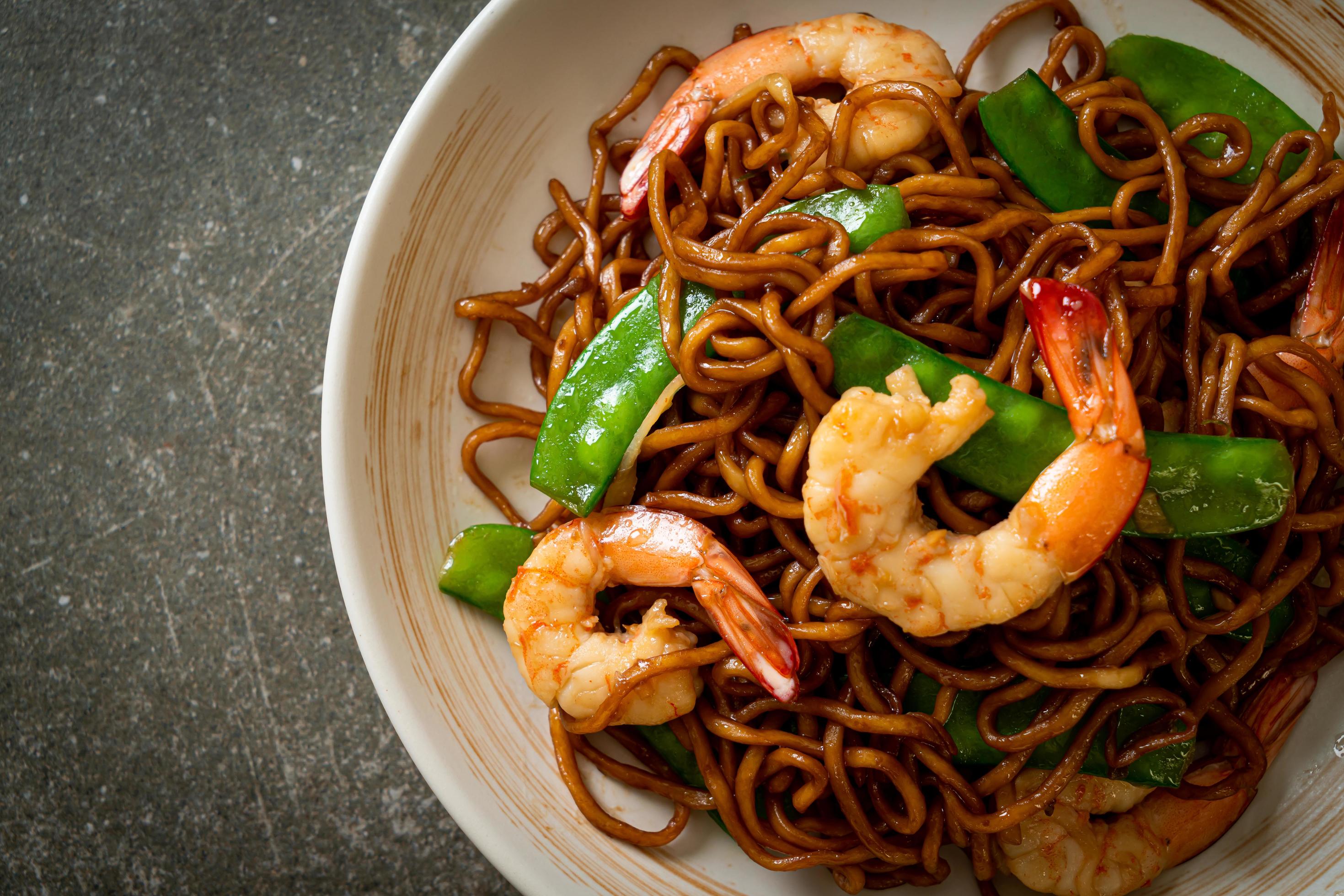 Stir-fried yakisoba noodles with green peas and shrimps – Asian food style Stock Free