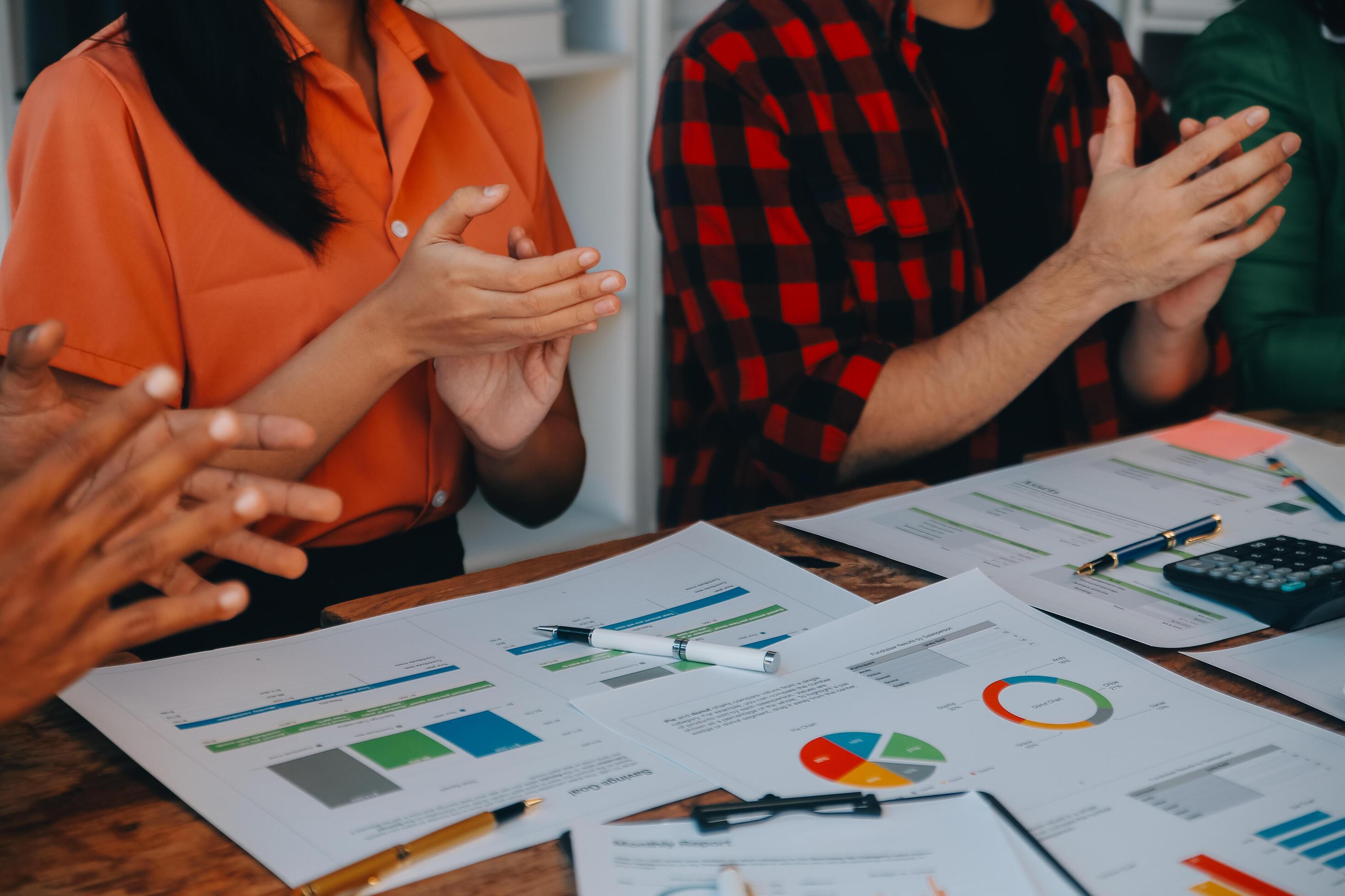 Cheerful business colleagues applauding in meeting at coworking office Stock Free