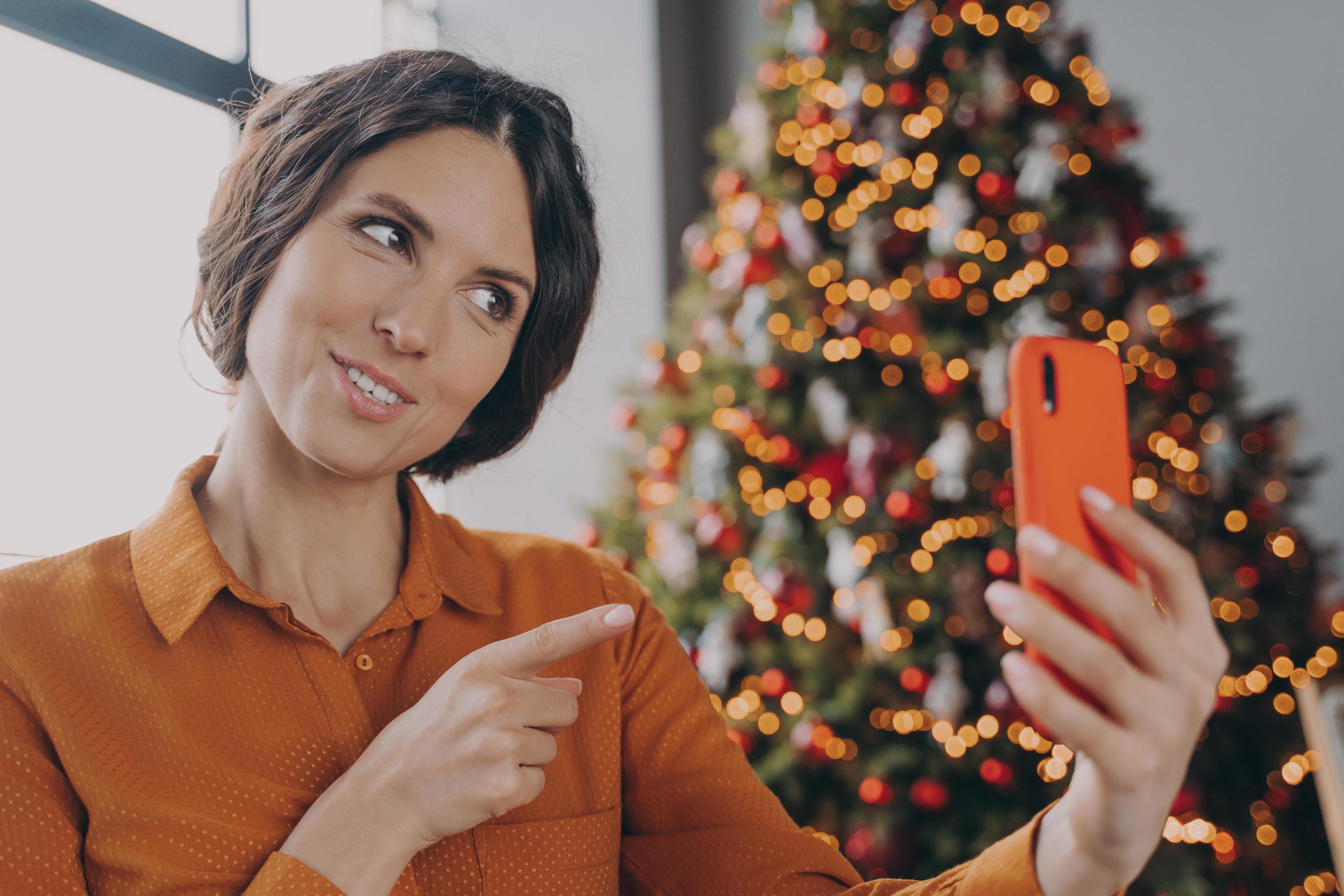 Happy italian female making video call during winter holidays, talking with family online Stock Free