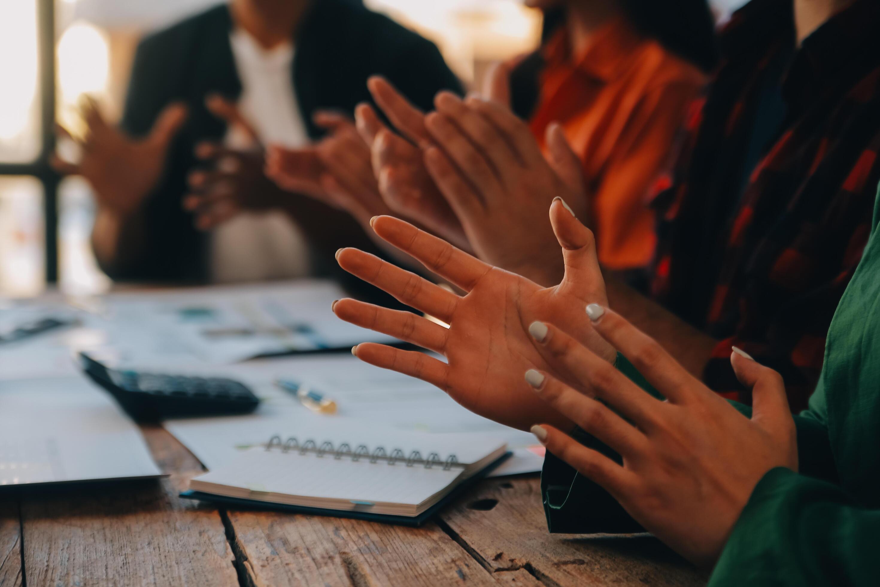 Cheerful business colleagues applauding in meeting at coworking office Stock Free