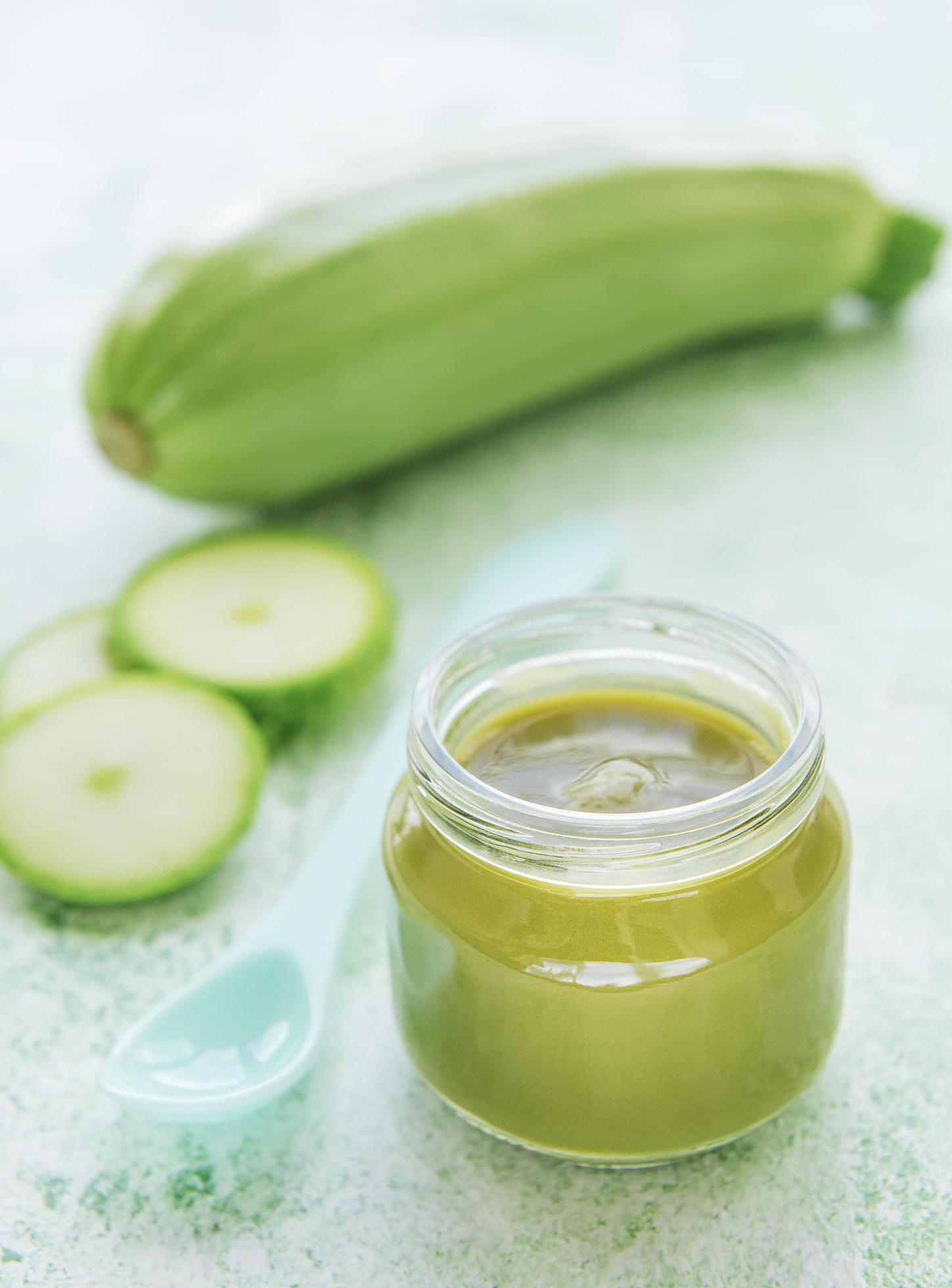 Jar with healthy baby food and zucchini Stock Free