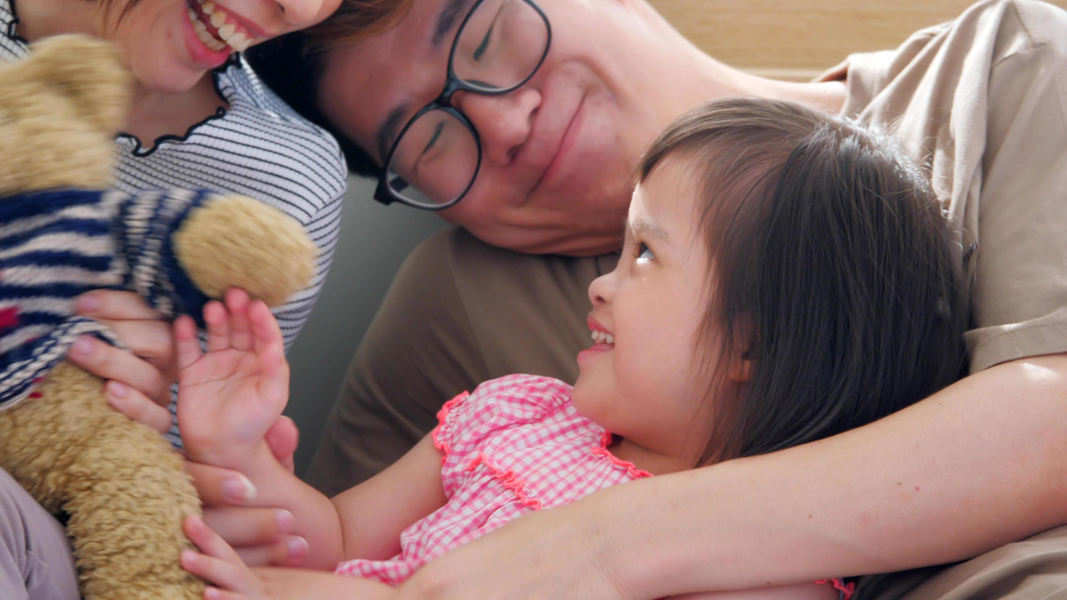 Happy family with mother, father and disabled daughter spending time together at home. Stock Free