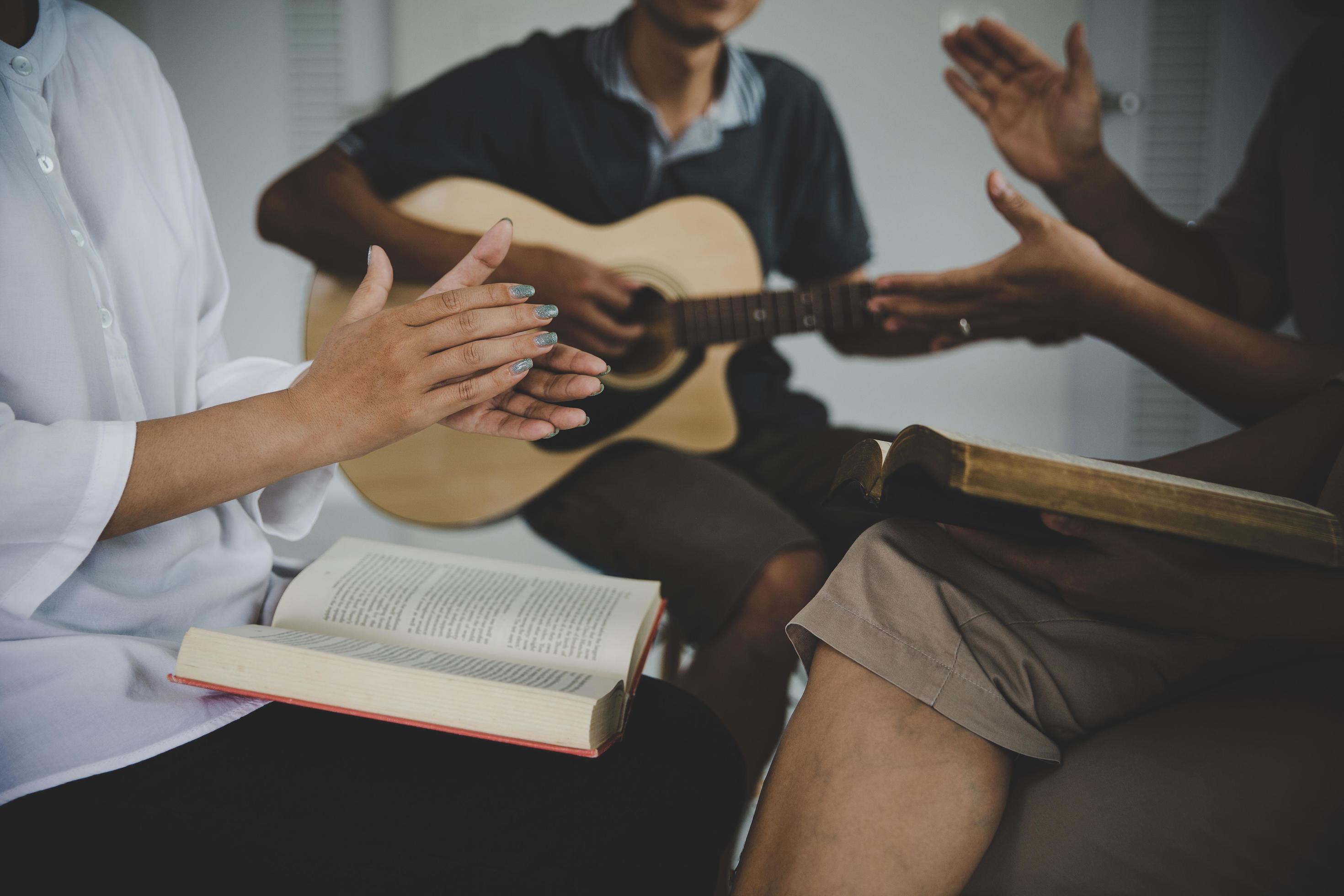 Christian family groups praying with Holy Bible. Stock Free