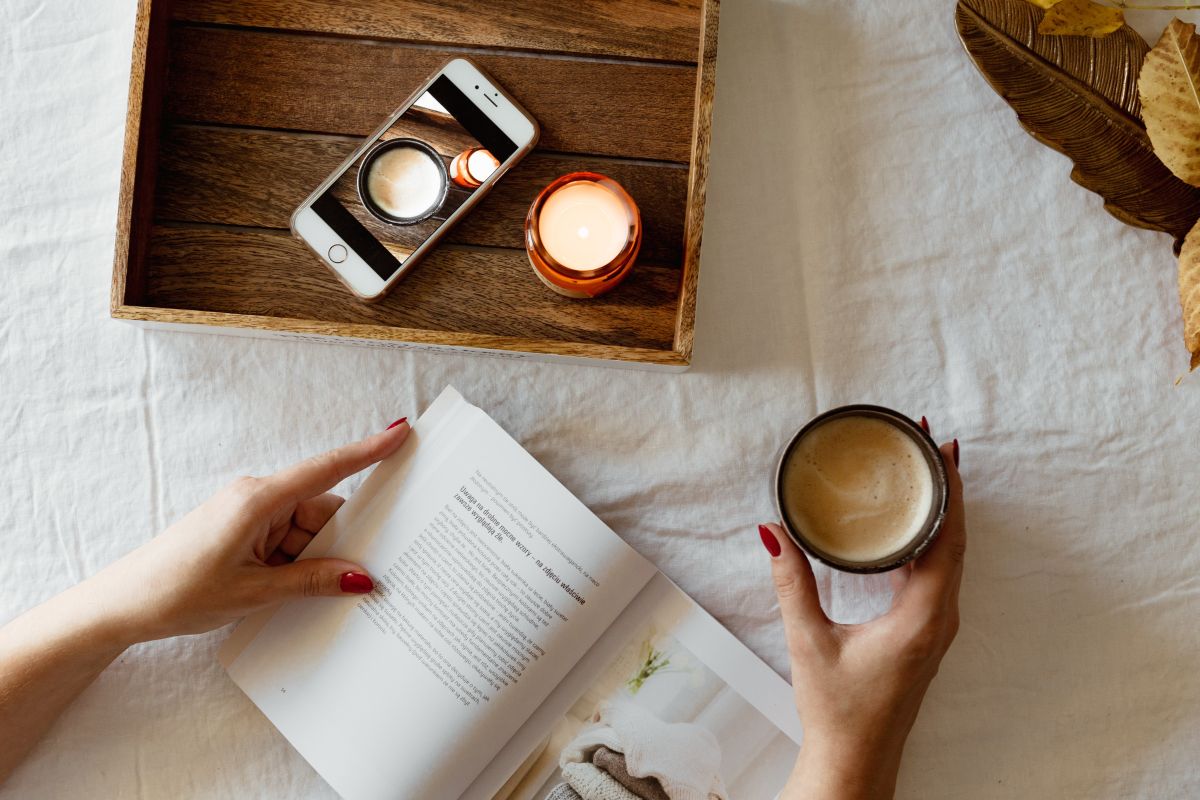 
									Woman read book and drink coffee Stock Free